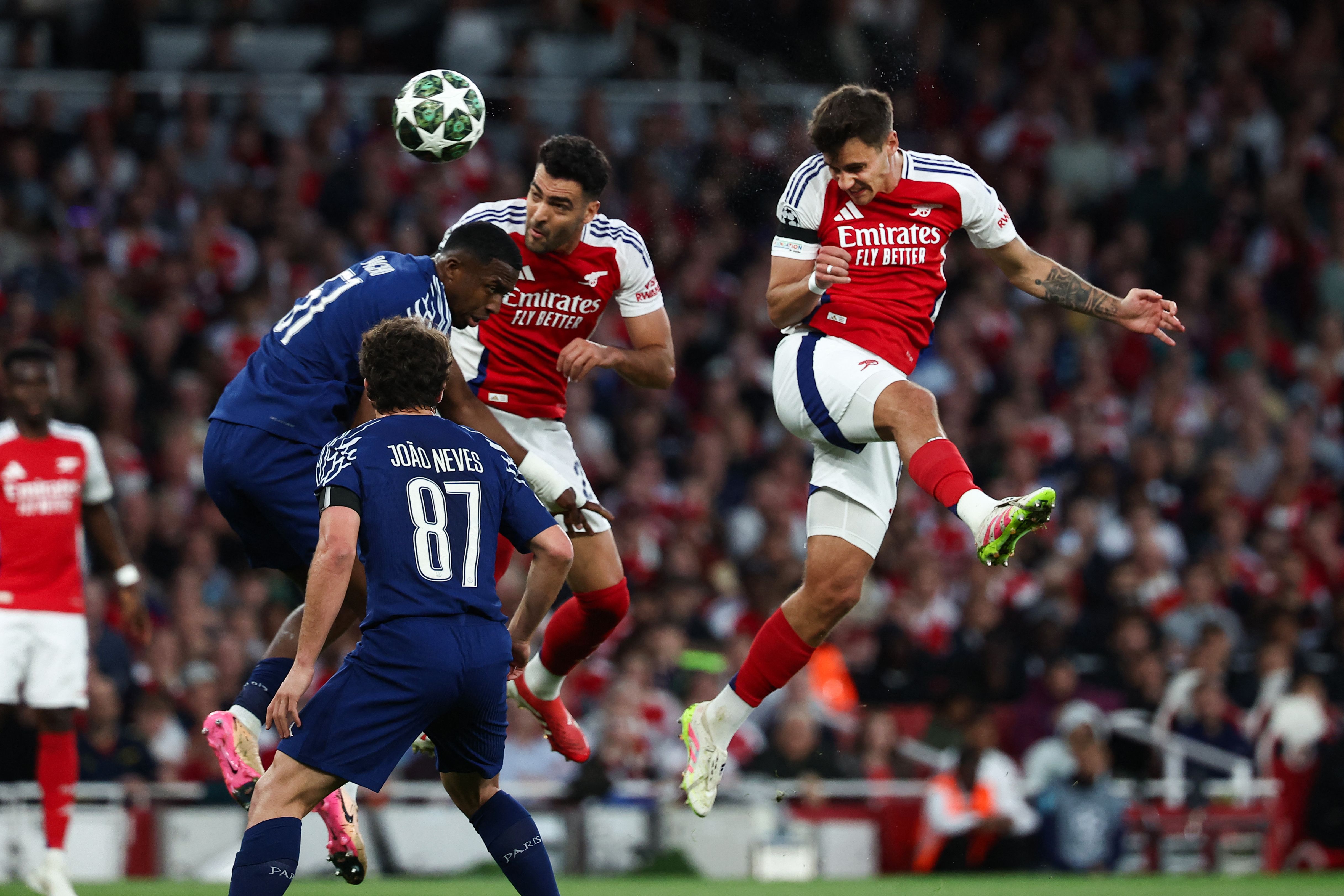 Arsenal's Polish defender #15 Jakub Kiwior (R) heads the ball past Arsenal's Spanish midfielder #23 Mikel Merino (2nd R) Paris Saint-Germain's Ecuadoran defender #51 Willian Pacho (2nd L) and Paris Saint-Germain's Portuguese midfielder #87 Joao Neves (front L) during the UEFA Champions League Semi-final First Leg football match between Arsenal and Paris Saint-Germain (PSG) at the Emirates Stadium in north London, on April 29, 2025. (Photo by FRANCK FIFE / AFP)