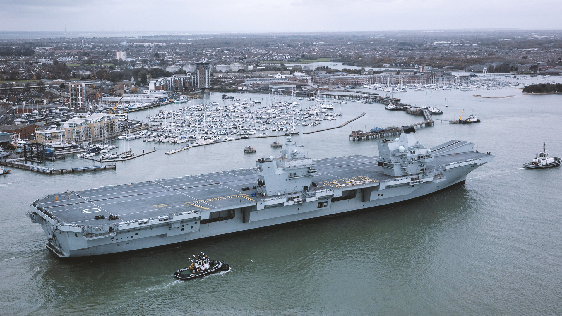 PORTSMOUTH, ENGLAND - NOVEMBER 21:  HMS Queen Elizabeth sails into her home port of Portsmouth Naval Base following sea trials and ahead of being formally commissioned into the Royal Navy later next month, on November 21, 2017 in Portsmouth, England. HMS Queen Elizabeth is the lead ship in the new Queen Elizabeth class of supercarriers. Weighing in at 65,000 tonnes she is the largest warship deployed by the British Royal Navy. She is planned to be in service by 2020 and with a second ship, HMS Prince of Wales, to follow.  (Photo by Matt Cardy/Getty Images)