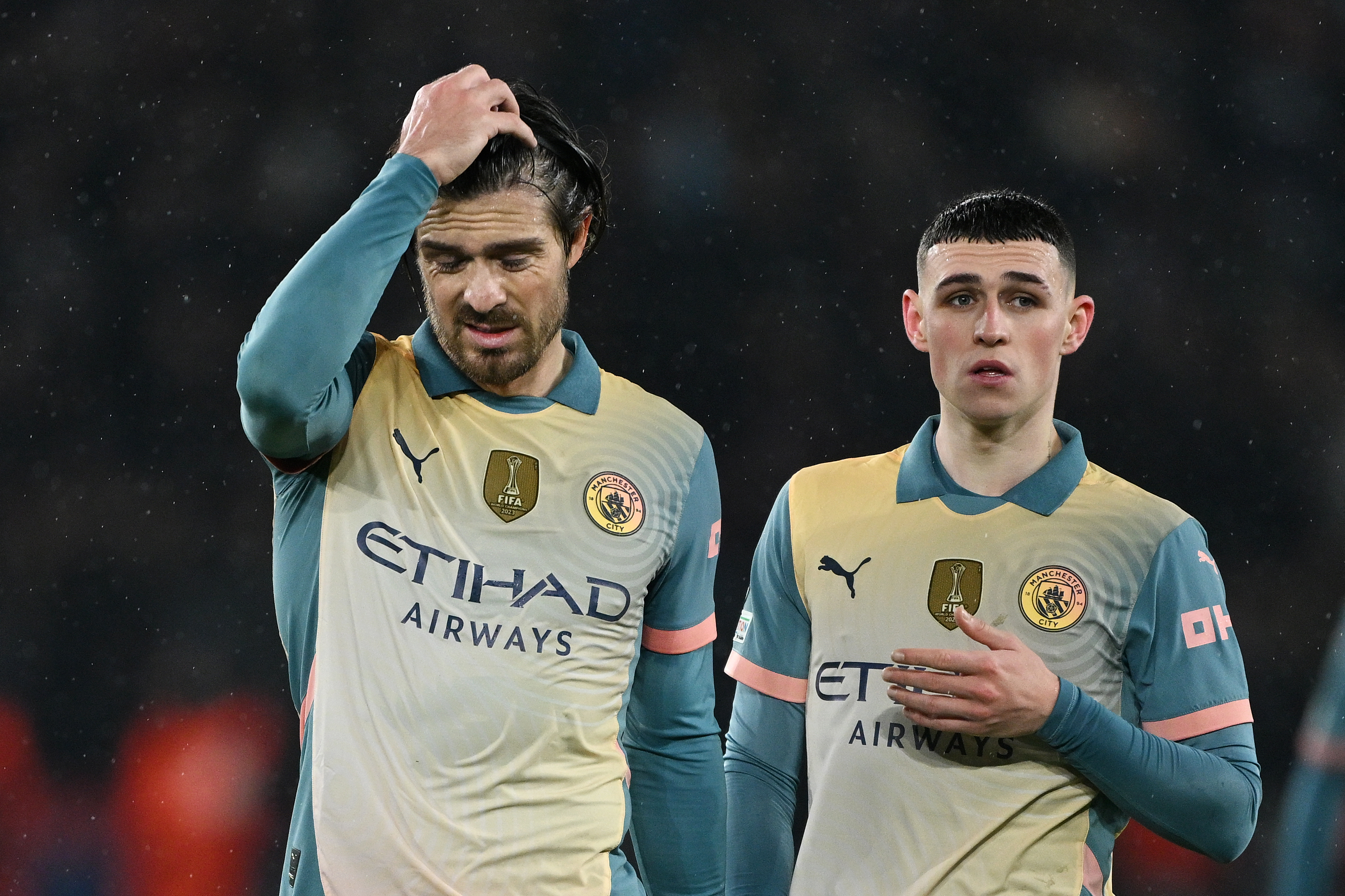 PARIS, FRANCE - JANUARY 22: Jack Grealish and Phil Foden of Manchester City look dejected after the team's defeat in the UEFA Champions League 2024/25 League Phase MD7 match between Paris Saint-Germain and Manchester City at Parc des Princes on January 22, 2025 in Paris, France. (Photo by Mike Hewitt/Getty Images)