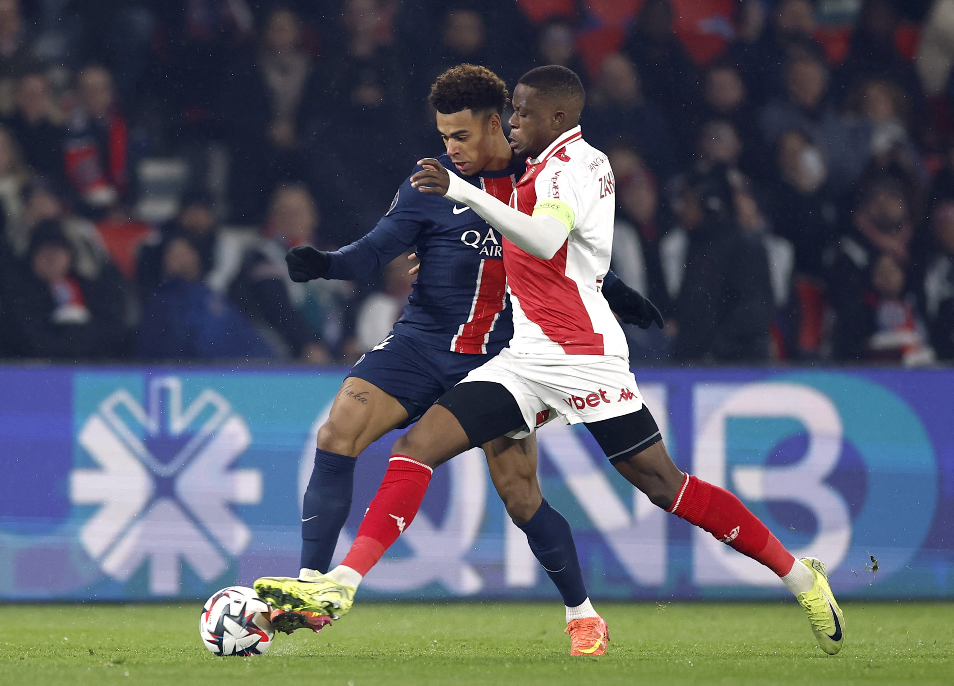 Soccer Football - Ligue 1 - Paris St Germain v AS Monaco - Parc des Princes, Paris, France - February 7, 2025 Paris St Germain's Desire Doue in action with AS Monaco's Denis Zakaria REUTERS/Gonzalo Fuentes
