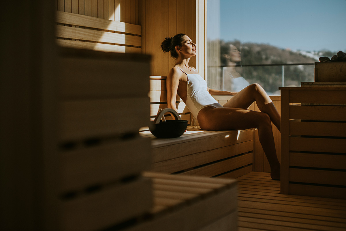 A woman resting in a wood-lined sauna in Cape Town