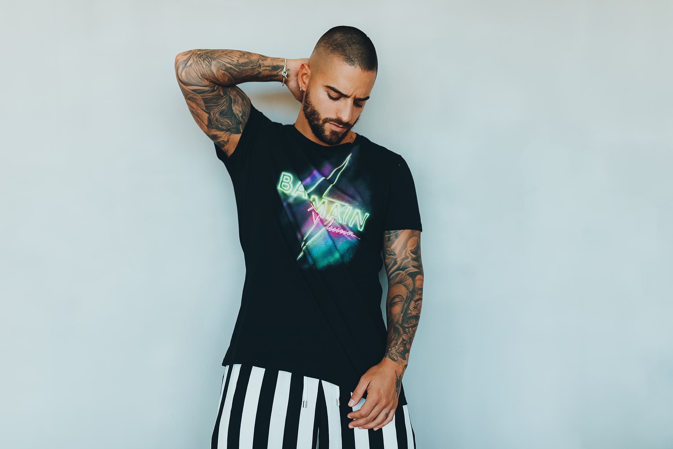 Maluma, wearing a black Off-White printed t-shirt, white sporty pants  News Photo - Getty Images