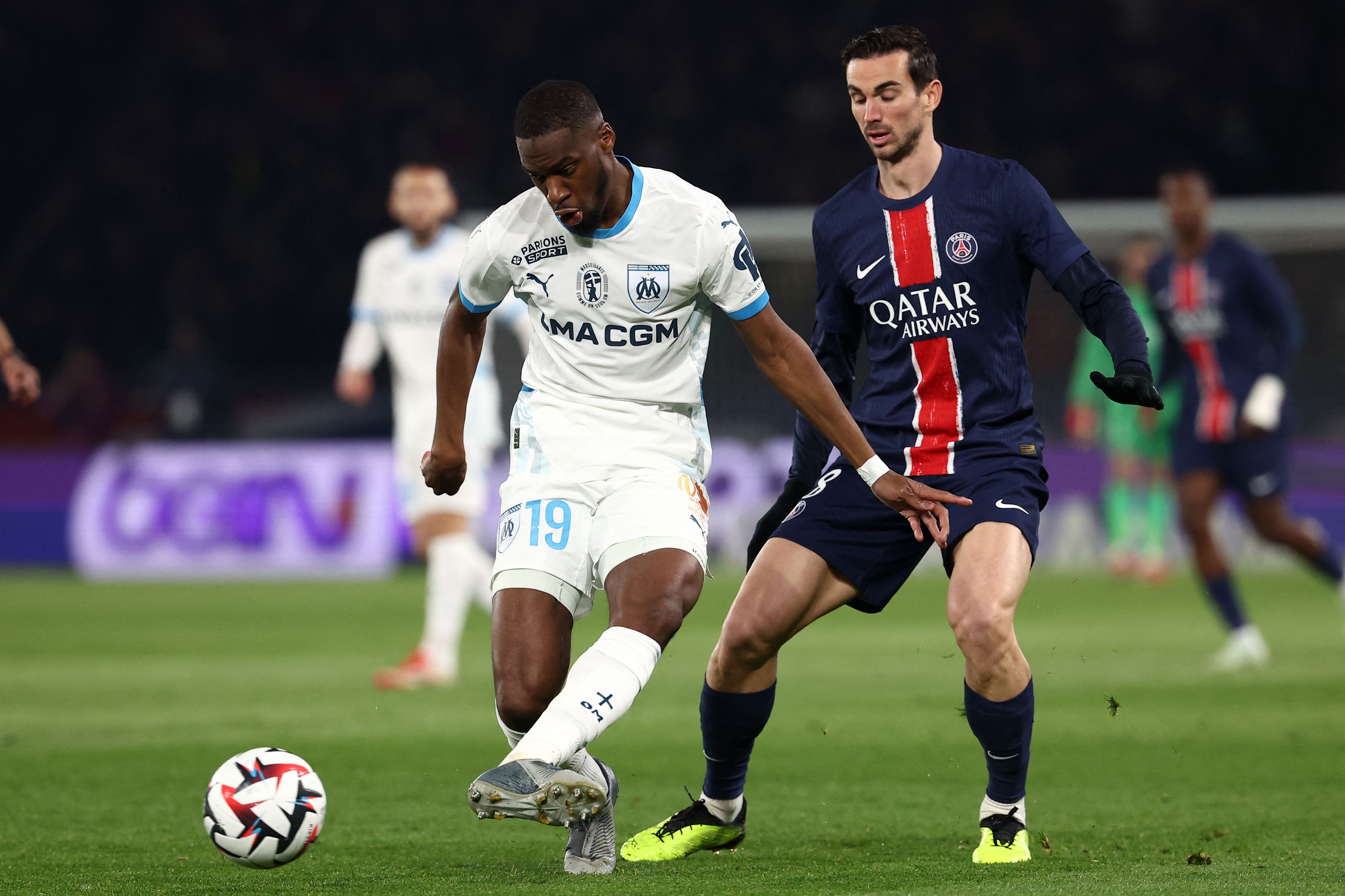 Marseille's Central African Republic's midfielder #19 Geoffrey Kondogbia (L) fights for the ball with Paris Saint-Germain's Spanish midfielder #08 Fabian Ruiz during the French L1 football match between Paris Saint-Germain (PSG) and Olympique de Marseille (OM) at the Parc des Princes Stadium in Paris, on March 16, 2025. (Photo by FRANCK FIFE / AFP)