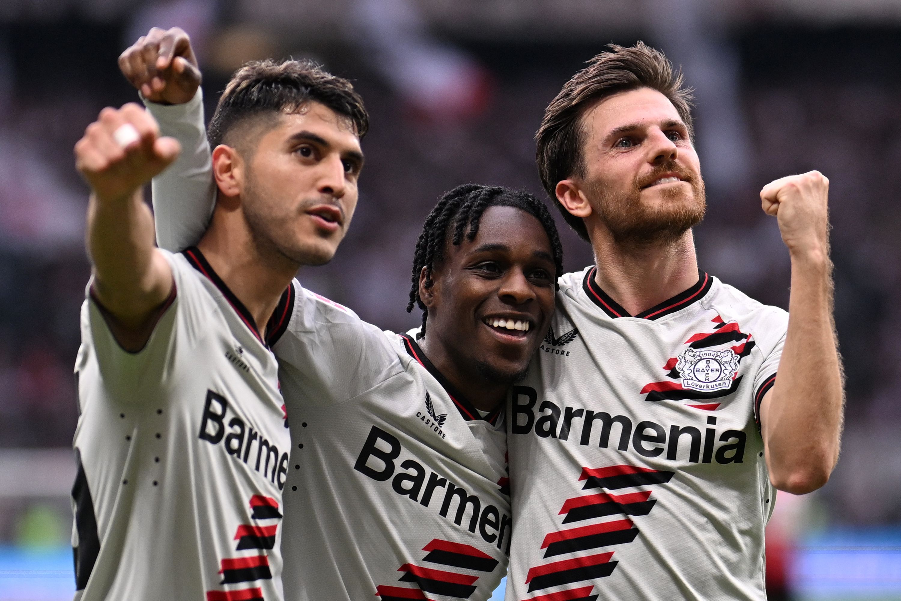 Bayer Leverkusen's Dutch defender #30 Jeremie Frimpong (C), Bayer Leverkusen's German midfielder #07 Jonas Hofmann (R) and Bayer Leverkusen's Argentine midfielder #25 Exequiel Palacios celebrate scoring a goal during the German first division Bundesliga football match between Eintracht Frankfurt and Bayer 04 Leverkusen in Frankfurt am Main, western Germany on May 5, 2024. (Photo by Kirill KUDRYAVTSEV / AFP) / DFL REGULATIONS PROHIBIT ANY USE OF PHOTOGRAPHS AS IMAGE SEQUENCES AND/OR QUASI-VIDEO