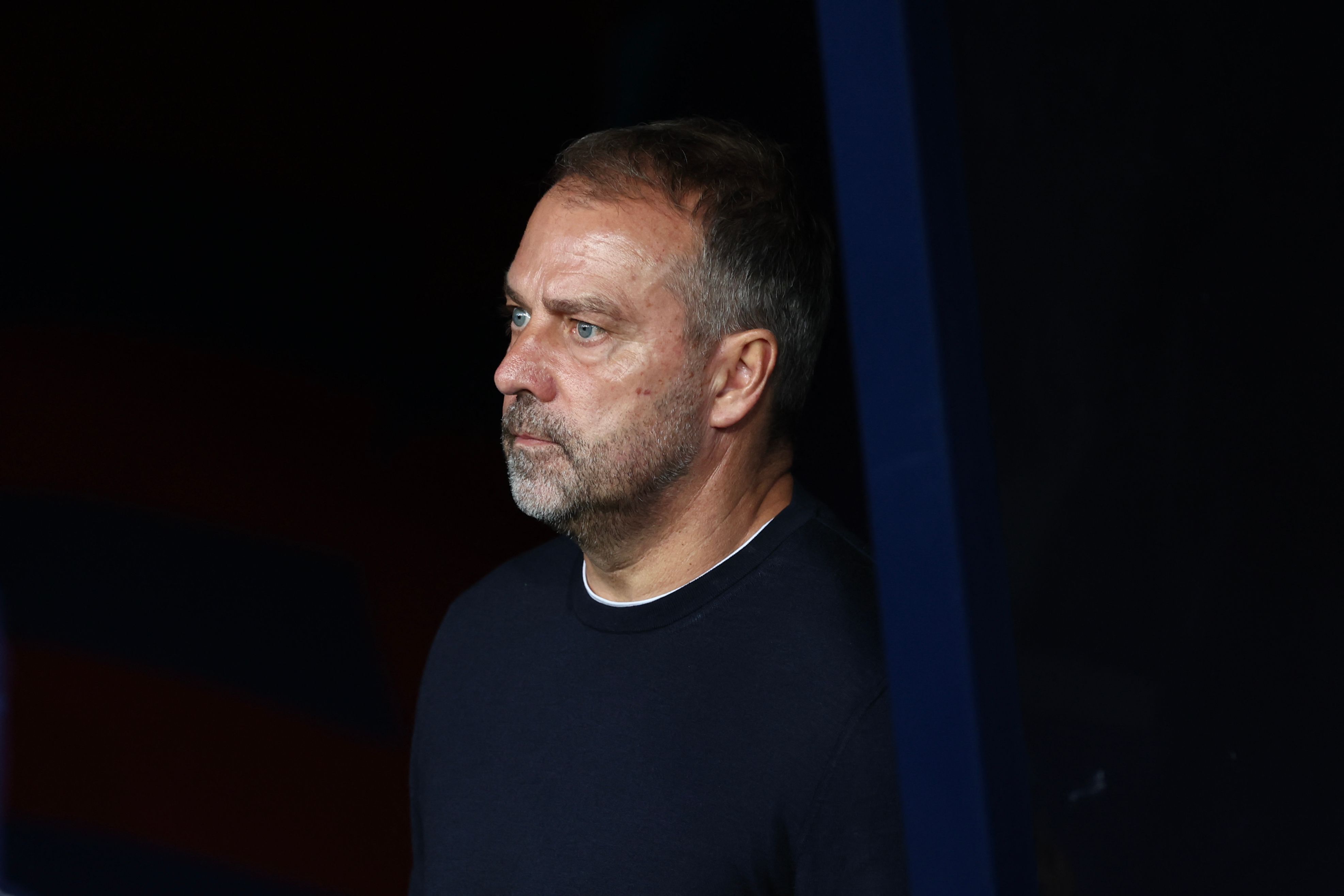 Barcelona's German coach Hans-Dieter Flick looks onb during the UEFA Champions League league phase match-day 3 football match between FC Barcelona and Olympiakos FC at Estadi Olimpic Lluis Companys in Barcelona on October 21, 2025. (Photo by Josep LAGO / AFP)