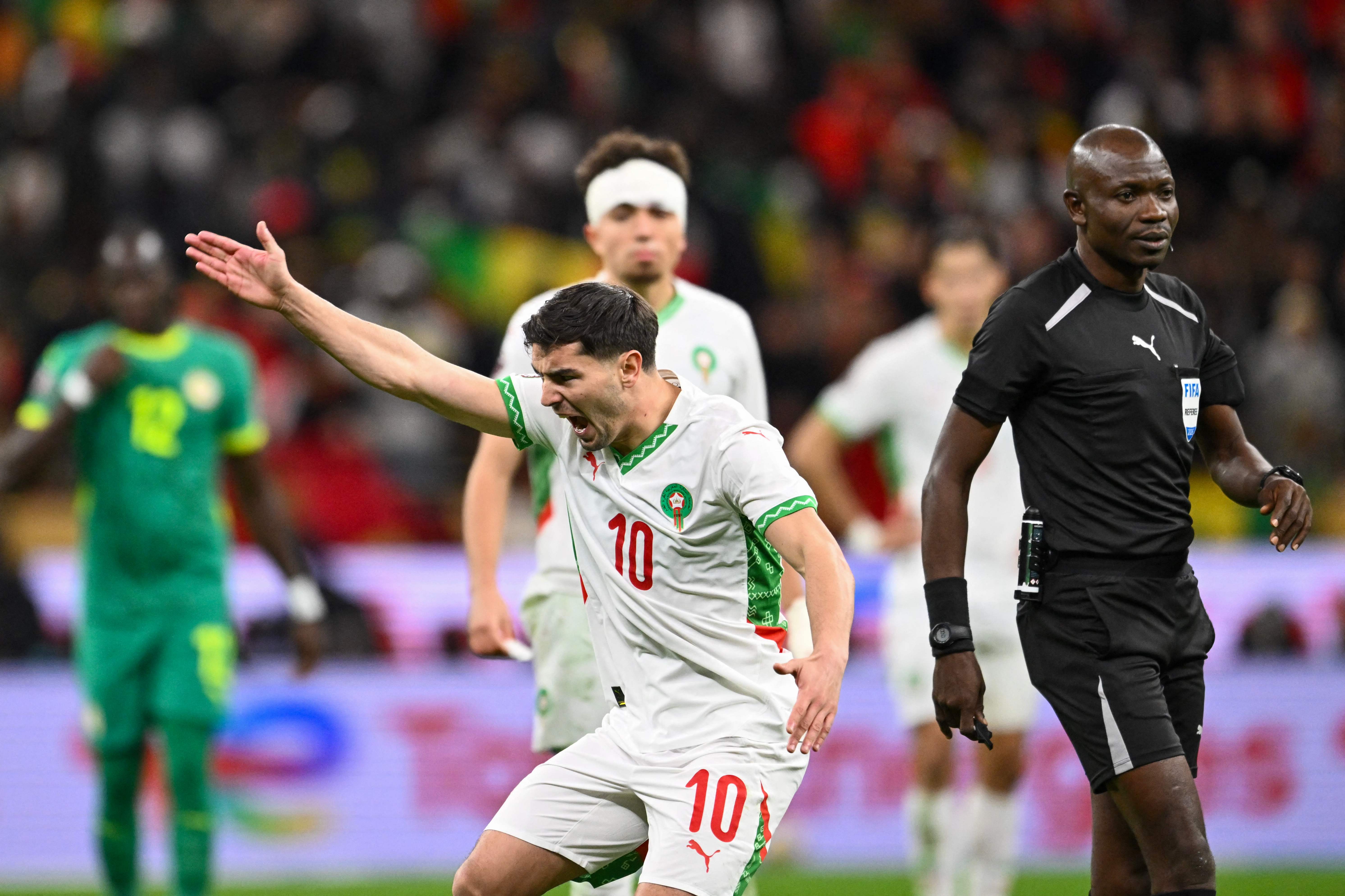 Morocco's forward #10 Brahim Diaz reacts in front of Congolese referee Jean-Jacques Ndala Ngambo during the Africa Cup of Nations (CAN) final football match between Senegal and Morocco at the Prince Moulay Abdellah Stadium in Rabat on January 18, 2026. (Photo by SEBASTIEN BOZON / AFP)