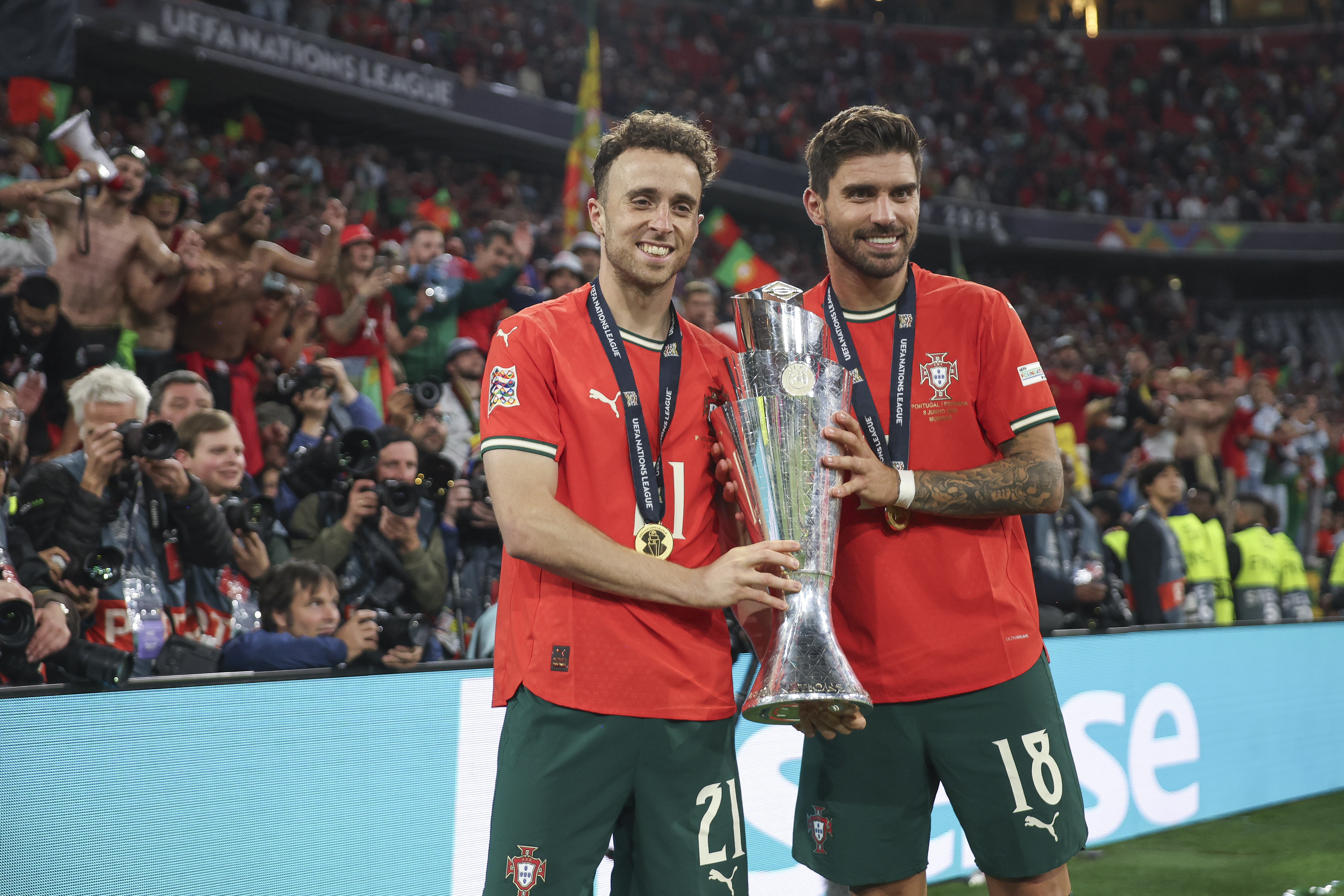 MUNICH, GERMANY - JUNE 08: Diogo Jota of Portugal and Ruben Neves pose for a photograph with the UEFA Nations League trophy after his team's victory in the UEFA Nations League 2025 final match between Portugal and Spain at Munich Football Arena on June 08, 2025 in Munich, Germany. (Photo by Maja Hitij - UEFA/UEFA via Getty Images)