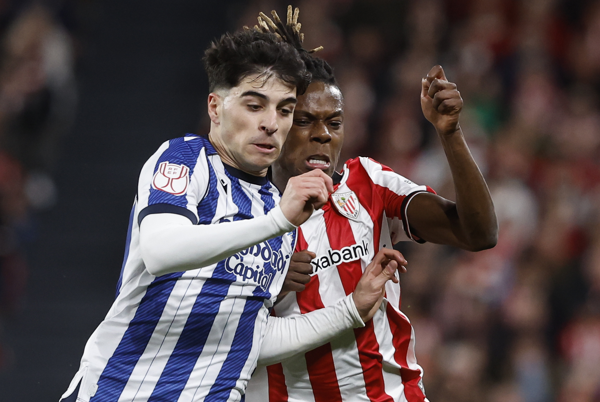 BILBAO, 11/02/2026.- El defensa de la Real Sociedad, Jon Martín (i), pelea ante el delantero del Athletic Club, Nico Williams, durante el partido de ida de la semifinales de la Copa del Rey que Athletic Club y Real Sociedad disputan este miércoles en el estadio de San Mamés, en Bilbao. EFE/ Miguel Toña.