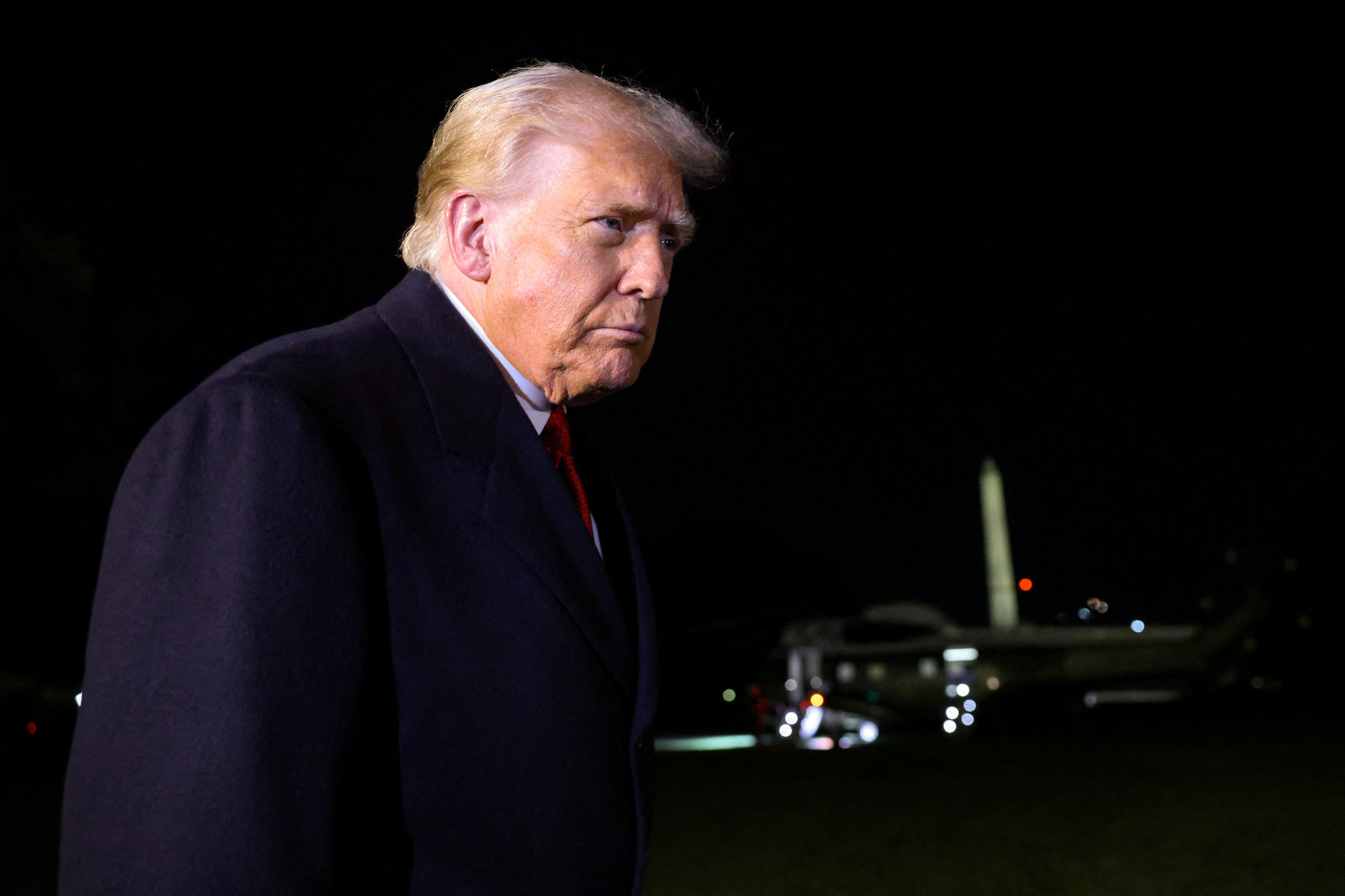U.S. President Donald Trump speaks to members of the media, with Marine One and the Washington Monument behind him, as he departs for Asia from the South Lawn of the White House in Washington, D.C., U.S., October 24, 2025. REUTERS/Kylie Cooper