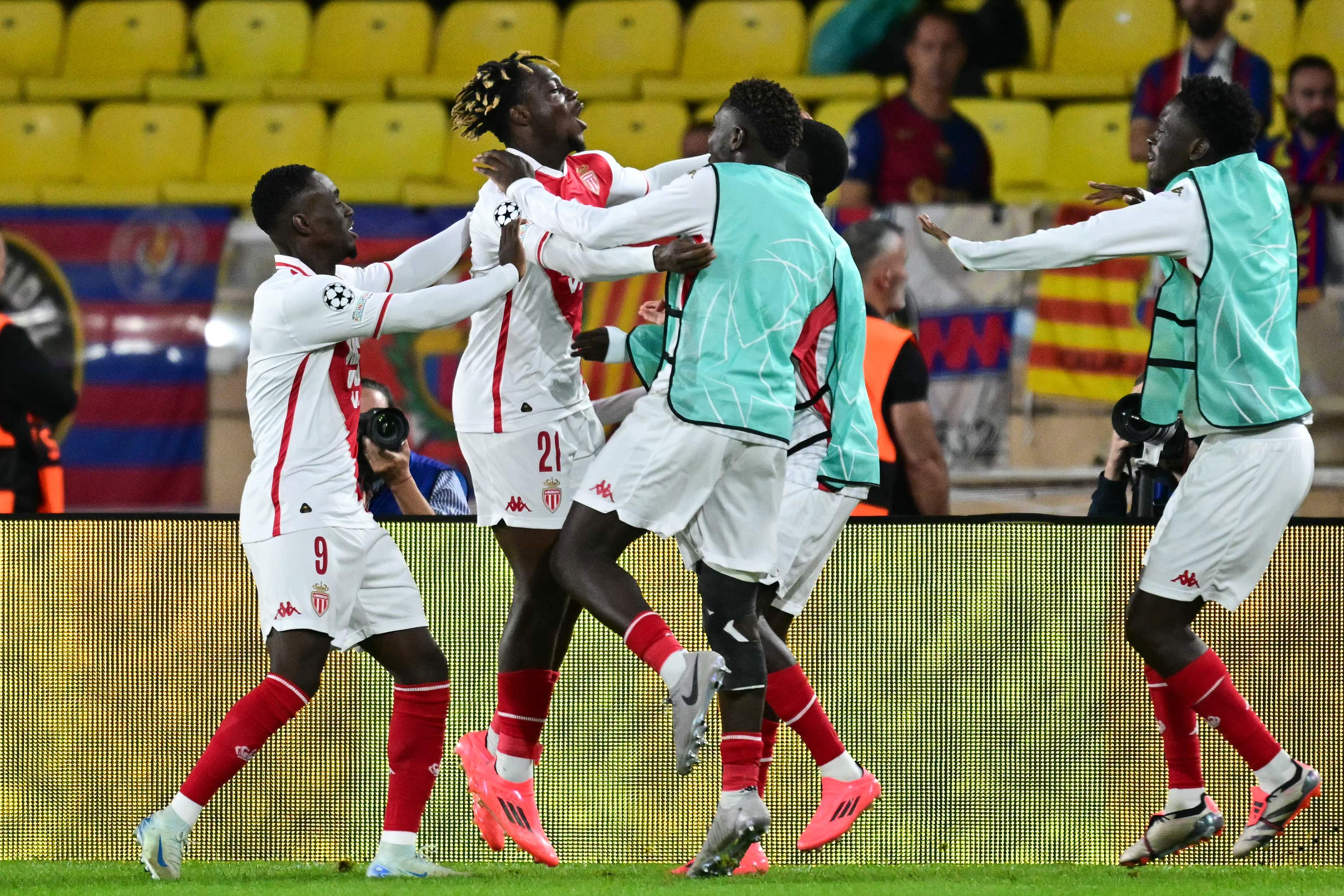 Monaco's French forward #21 George Ilenikhena (2L) celebrates with teammates after scoring his team's second goal during the UEFA Champions League 1st round day 1 football match between AS Monaco and FC Barcelona at the Louis II Stadium in the Principality of Monaco on September 19, 2024. (Photo by Miguel MEDINA / AFP)