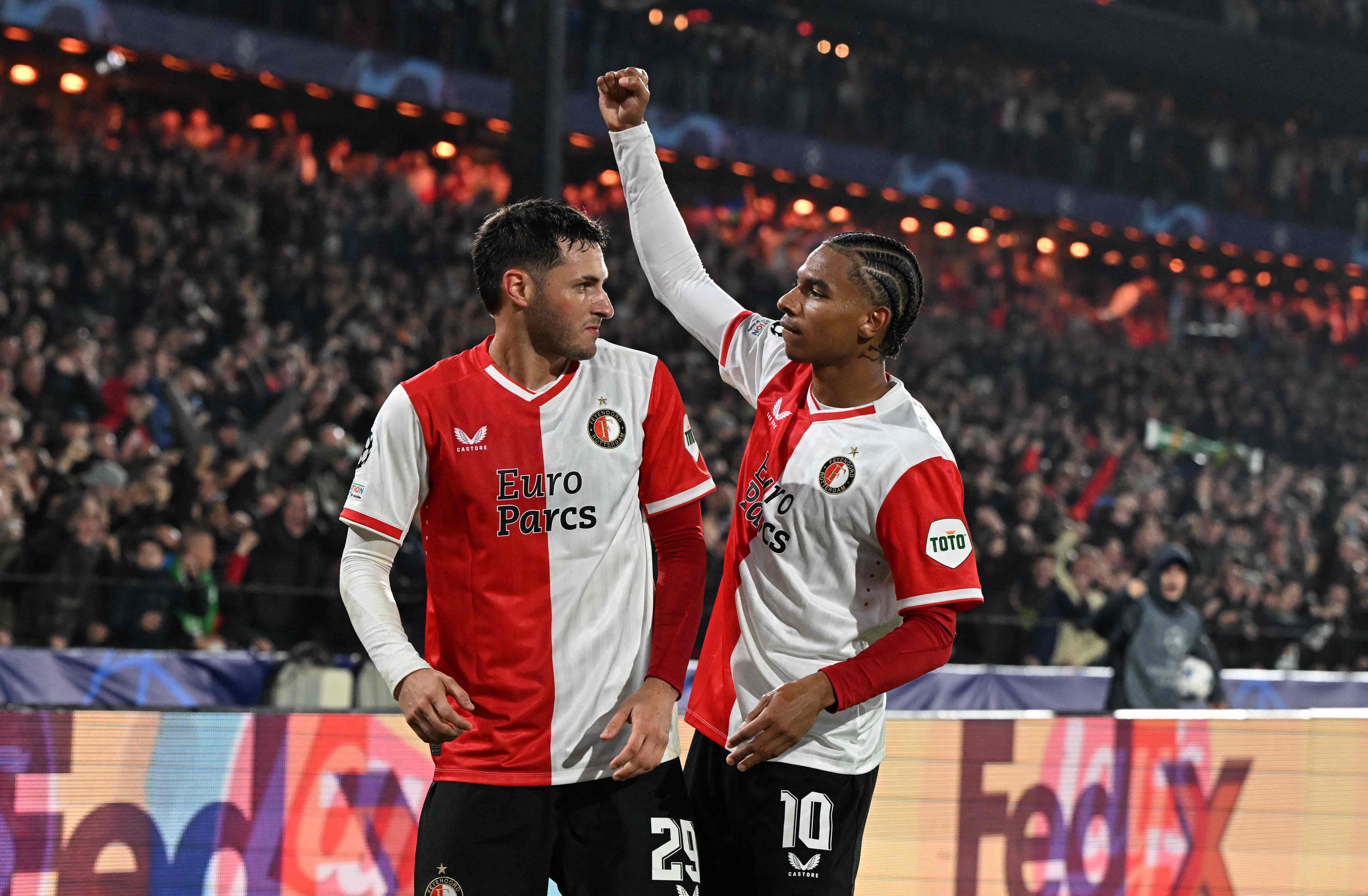 Feyenoord's Mexican forward #29 Santiago Gimenez celebrates with his teammates Feyenoord's Dutch midfielder #10 Calvin Stengs after scoring his team's thirs goal during the UEFA Champions League Group E football match between Feyenoord and Lazio at The De Kuip Stadium, in Rotterdam on October 25, 2023. cel (Photo by JOHN THYS / AFP)