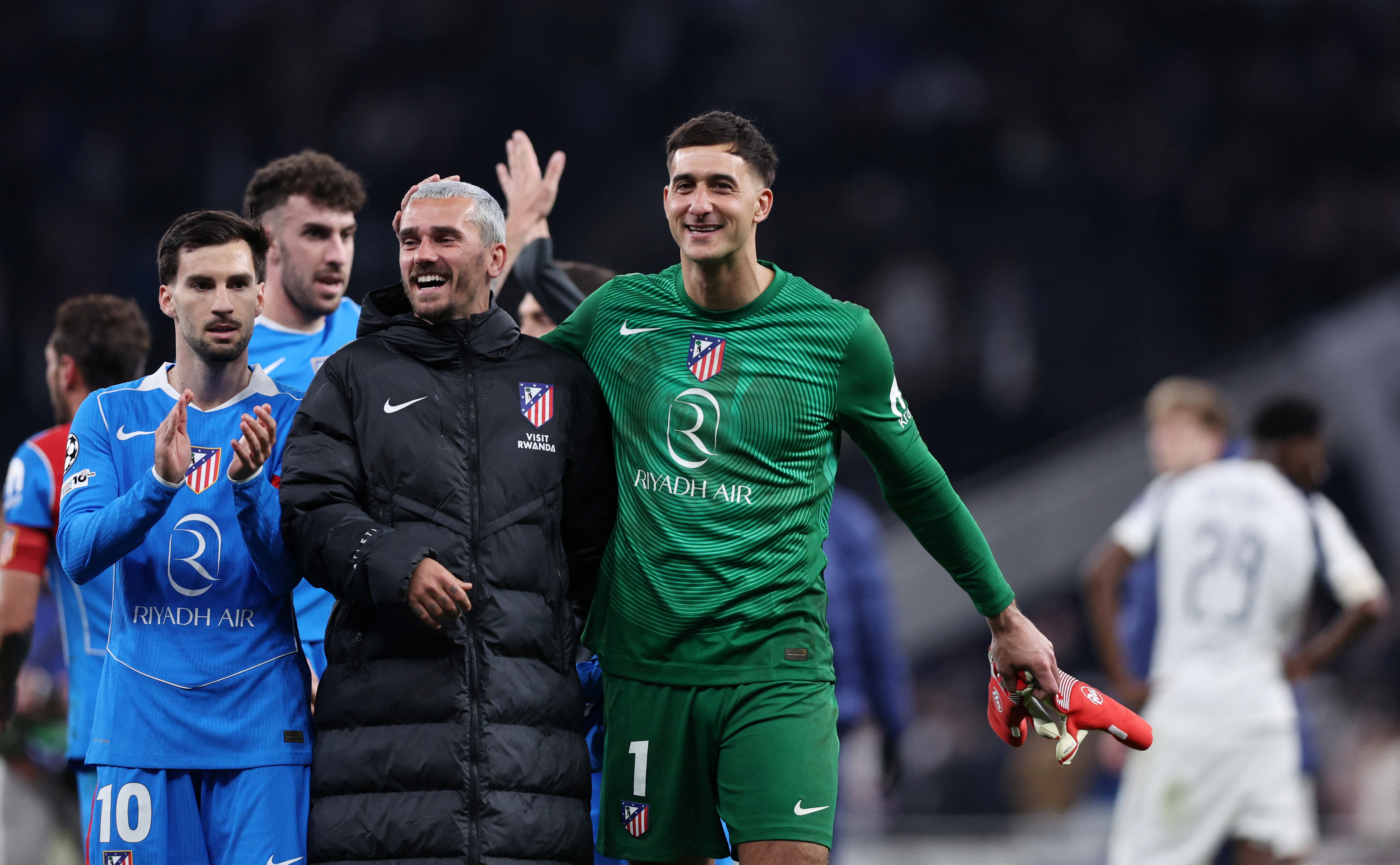 Soccer Football - UEFA Champions League - Round 16 - Second Leg - Tottenham Hotspur v Atletico Madrid - Tottenham Hotspur Stadium, London, Britain - March 18, 2026 Atletico Madrid's Alex Baena, Antoine Griezmann and Juan Musso celebrate after the match REUTERS/David Klein