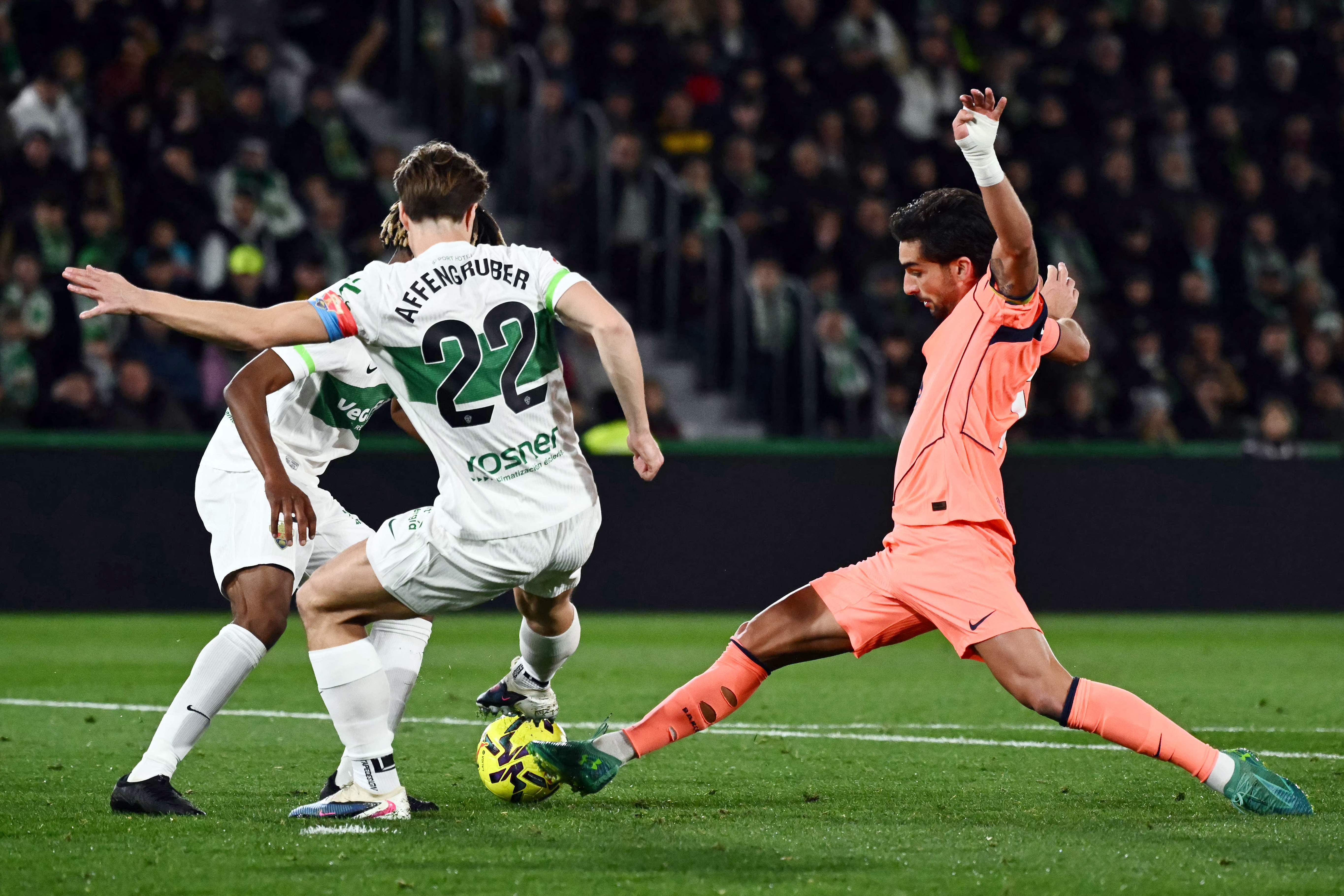 Barcelona's Spanish forward #07 Ferran Torres (R) and Elche's Austrian defender #22 David Affengruber fight for the ball during the Spanish league football match between Elche CF and FC Barcelona at thge Martinez Valero stadium in Elche on January 31, 2026. (Photo by JOSE JORDAN / AFP)
