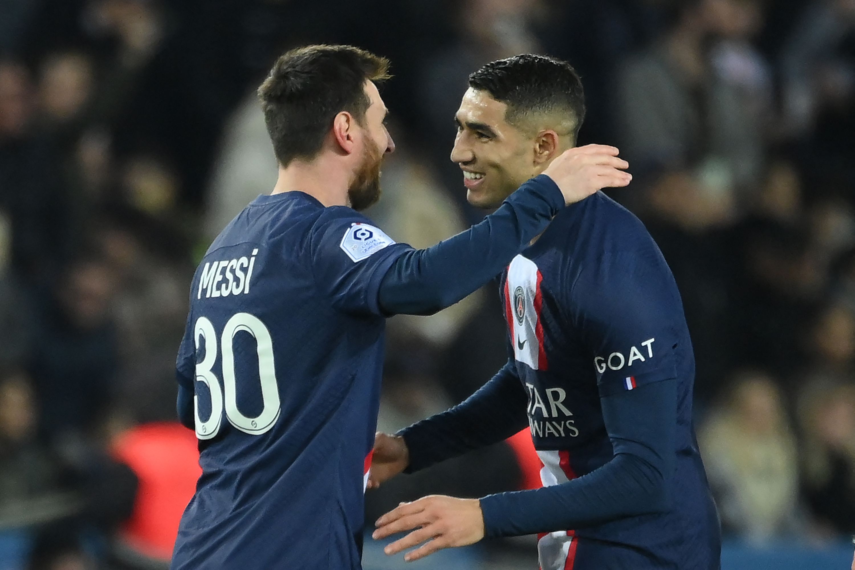 Paris Saint-Germain's Argentine forward Lionel Messi (L) celebrates with Paris Saint-Germain's Moroccan defender Achraf Hakimi after scoring his team's second goal during the French L1 football match between Paris Saint-Germain (PSG) and Toulouse FC at the Parc des Princes stadium in Paris on February 4, 2023. (Photo by FRANCK FIFE / AFP)