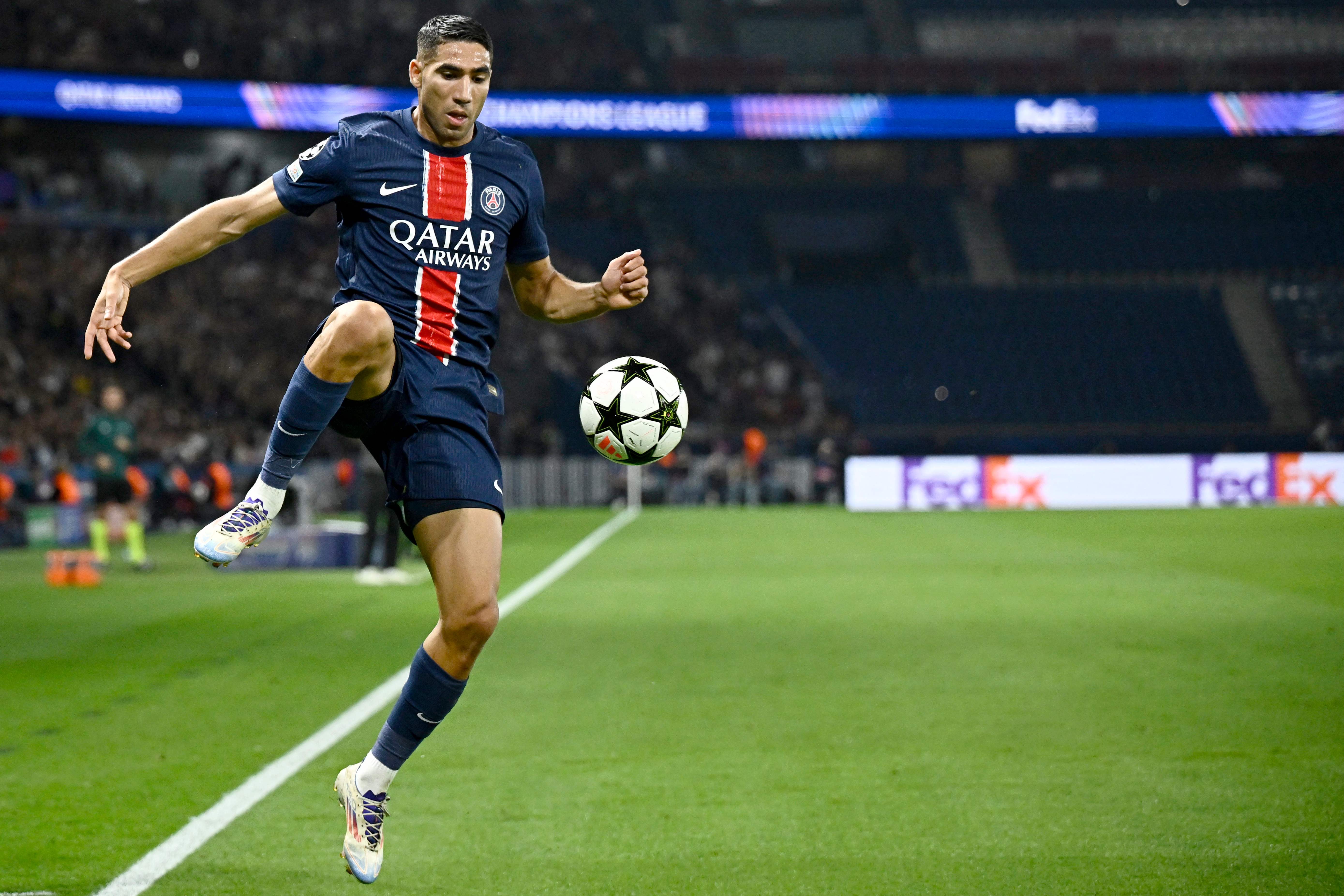 Paris Saint-Germain's Moroccan midfielder #02 Achraf Hakimi controls the ball during the UEFA Champions League 1st round day 1 football match between Paris Saint-Germain (PSG) and Girona FC at the Parc des Princes Stadium, in Paris, on September 18, 2024. (Photo by JULIEN DE ROSA / AFP)