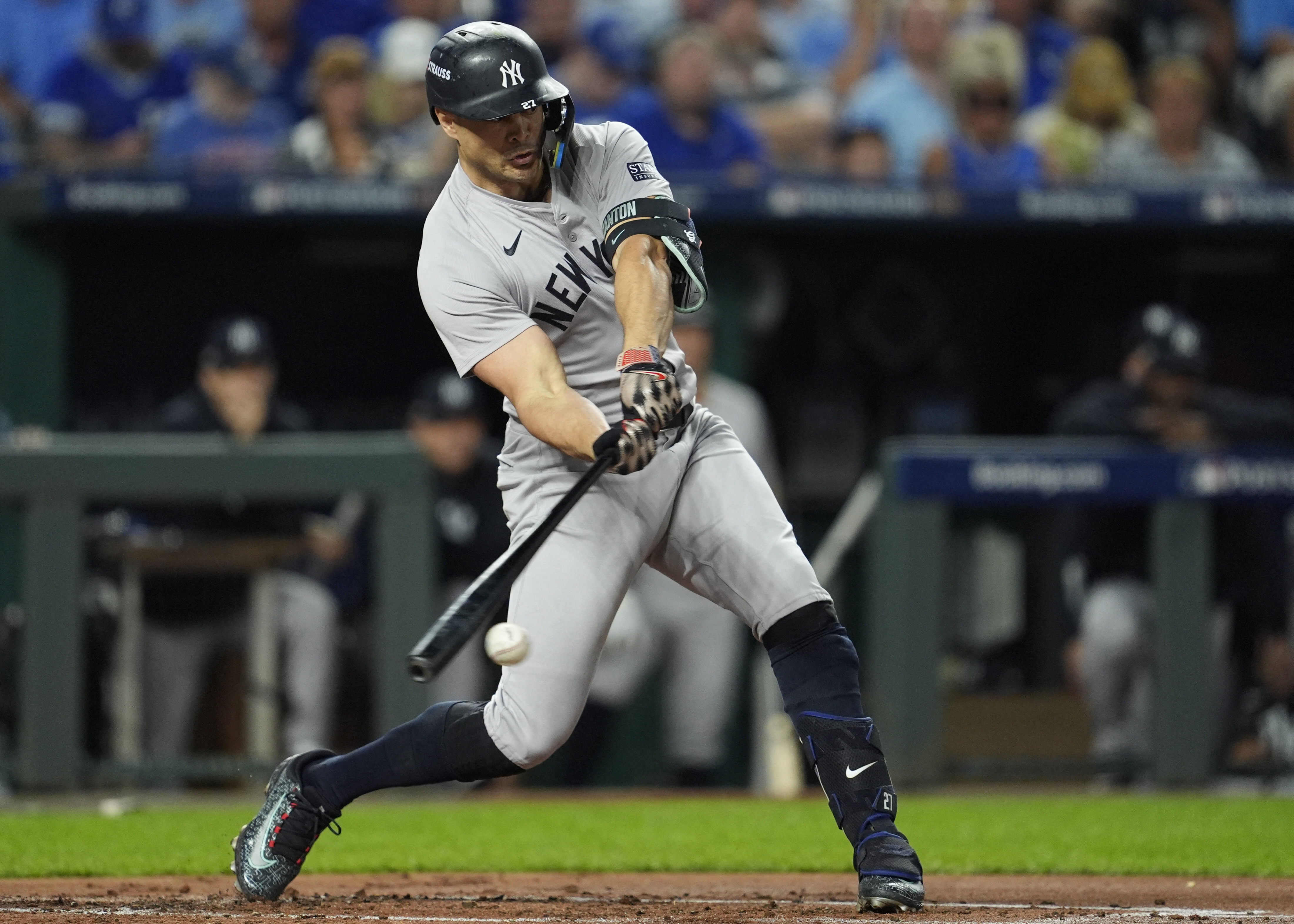 Oct 10, 2024; Kansas City, Missouri, USA; New York Yankees designated hitter Giancarlo Stanton (27) hits a double during the second inning against the Kansas City Royals during game four of the ALDS for the 2024 MLB Playoffs at Kauffman Stadium. Mandatory Credit: Jay Biggerstaff-Imagn Images