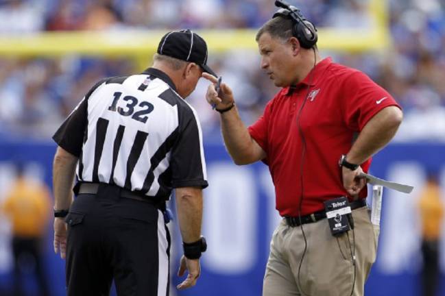 Referee John Parry (132) looks at a replay on the sidelines during the  first half of an NFL preseason football game between the Detroit Lions and  the New England Patriots, Friday, Aug.