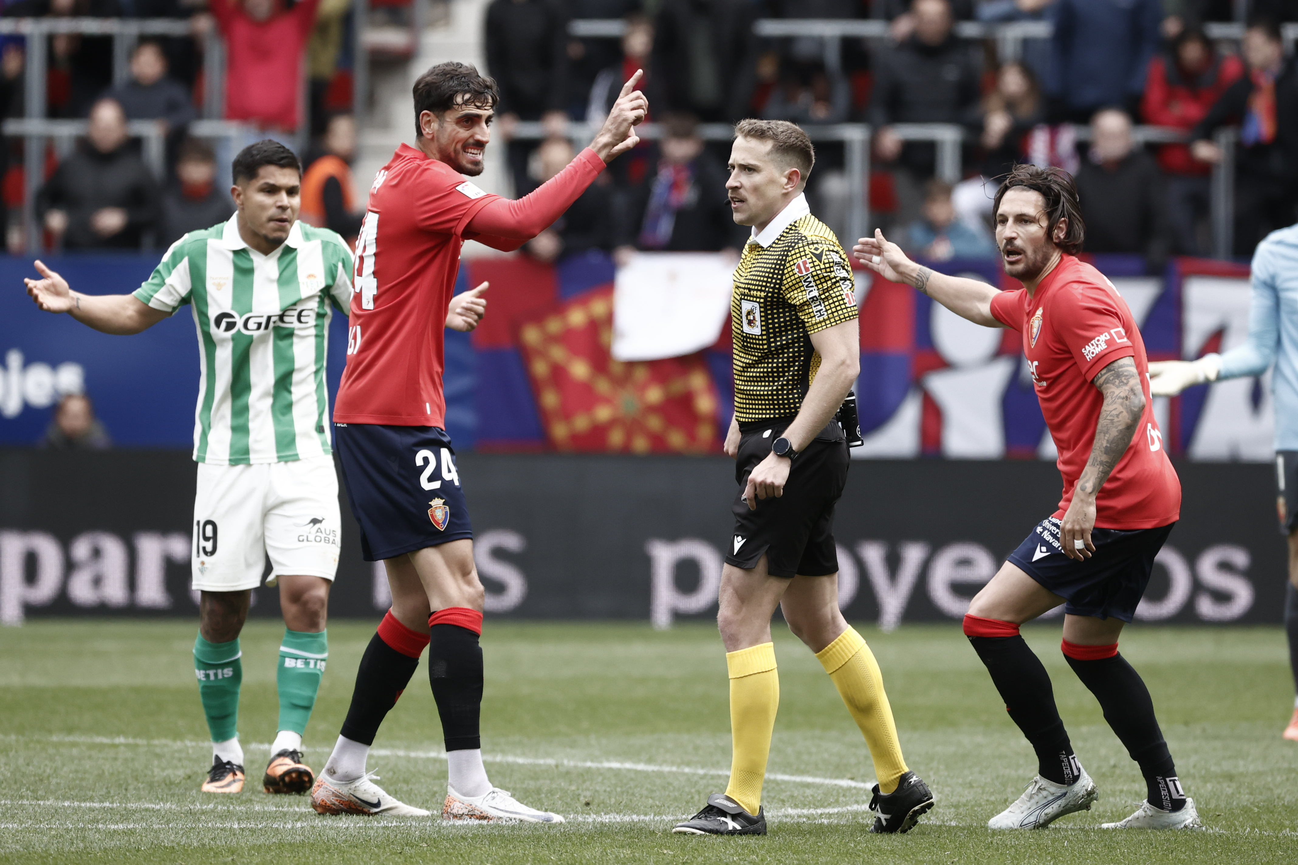 PAMPLONA, 12/04/2026.- El jugador del Osasuna Alejandro Catena (i) y el árbitro Sesma Espinosa, durante el partido de la jornada 31 de LaLiga EA Sports entre el Real Betis y Osasuna, este domingo en el estadio de El Sadar. EFE/ Jesús Diges
