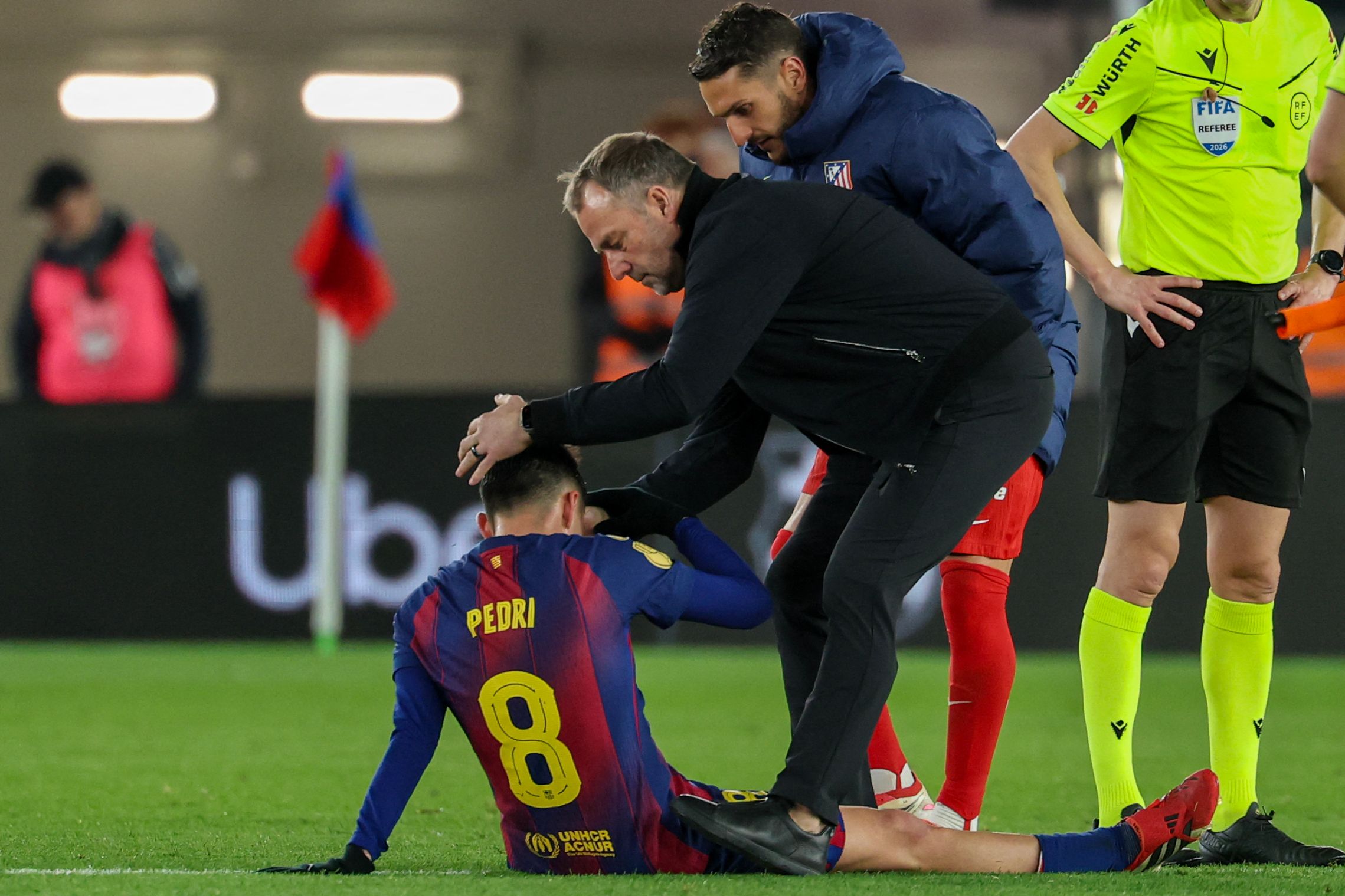 Barcelona's German coach Hans-Dieter Flick consoles Barcelona's Spanish midfielder #08 Pedri after the Copa del Rey (King's Cup) semi final second leg football match between FC Barcelona and Club Atletico de Madrid at Camp Nou Stadium in Barcelona on March 3, 2026. (Photo by Lluis GENE / AFP)