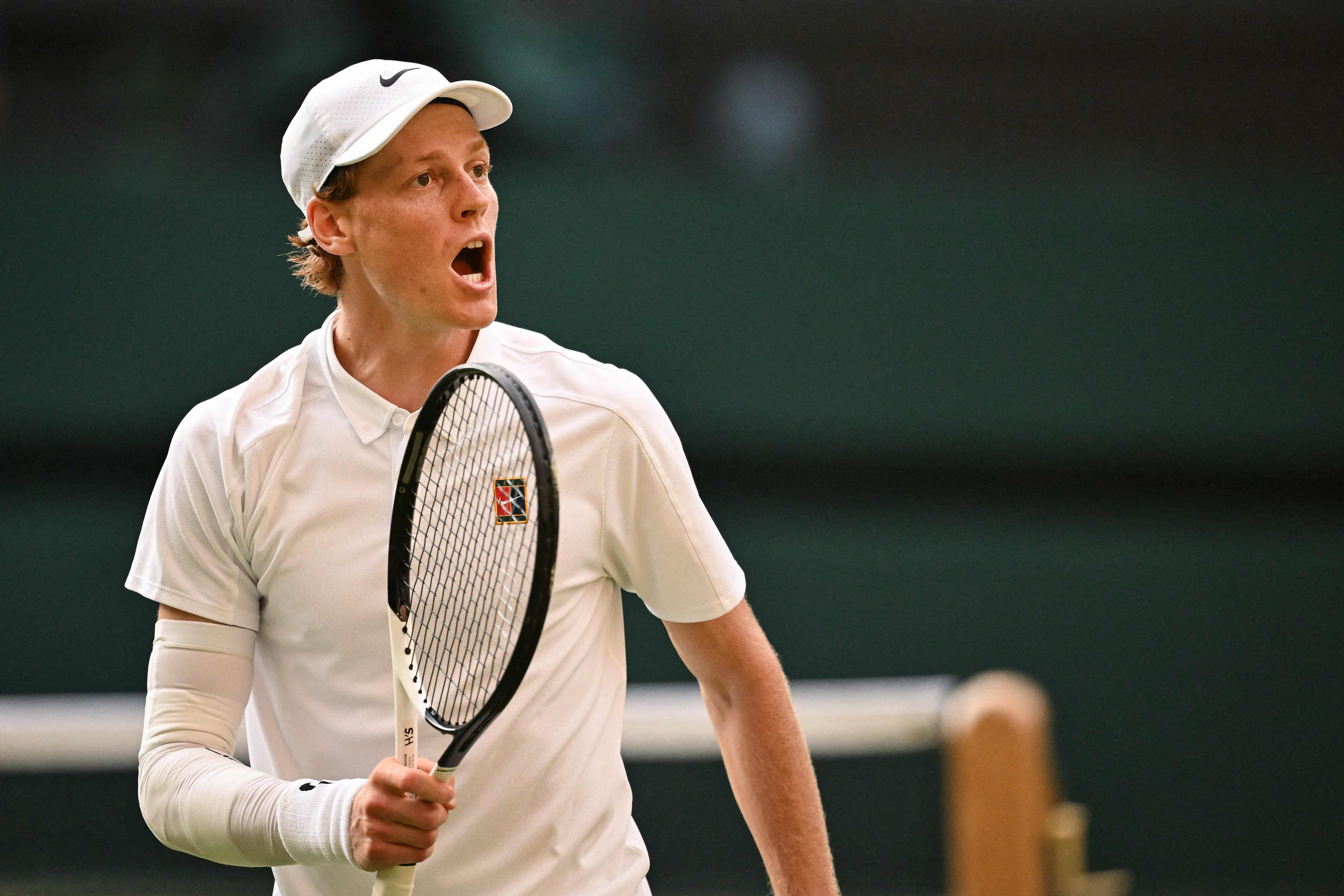 Italy's Jannik Sinner reacts as he plays against Spain's Carlos Alcaraz during their men's singles final tennis match on the fourteenth day of the 2025 Wimbledon Championships at The All England Lawn Tennis and Croquet Club in Wimbledon, southwest London, on July 13, 2025. (Photo by Kirill KUDRYAVTSEV / AFP) / RESTRICTED TO EDITORIAL USE