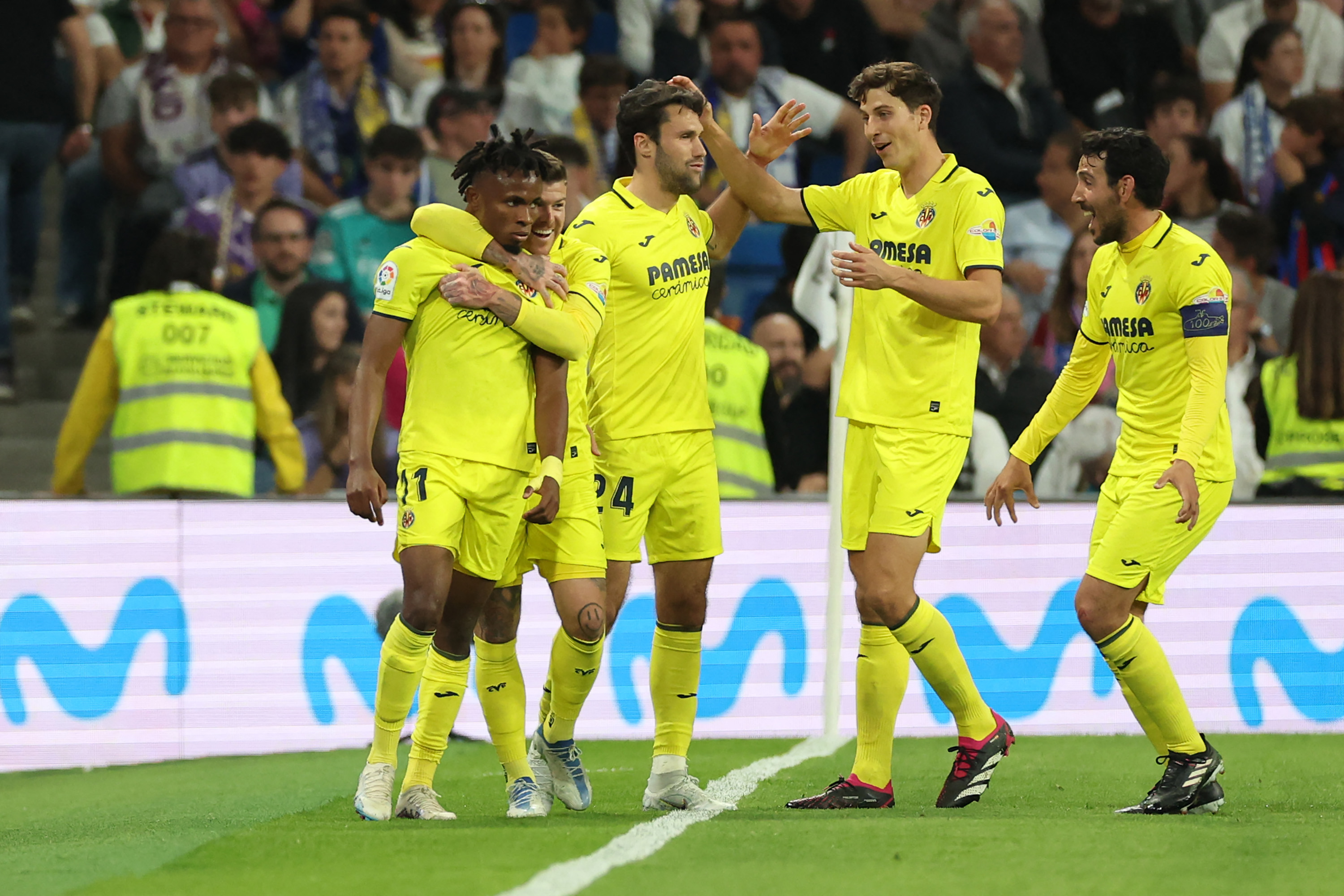 Villarreal's Nigerian midfielder Samuel Chukwueze (L) celebrates scoring his team's third goal during the Spanish league football match between Real Madrid CF and Villarreal CF at the Santiago Bernabeu stadium in Madrid on April 8, 2023. (Photo by Pierre-Philippe MARCOU / AFP)