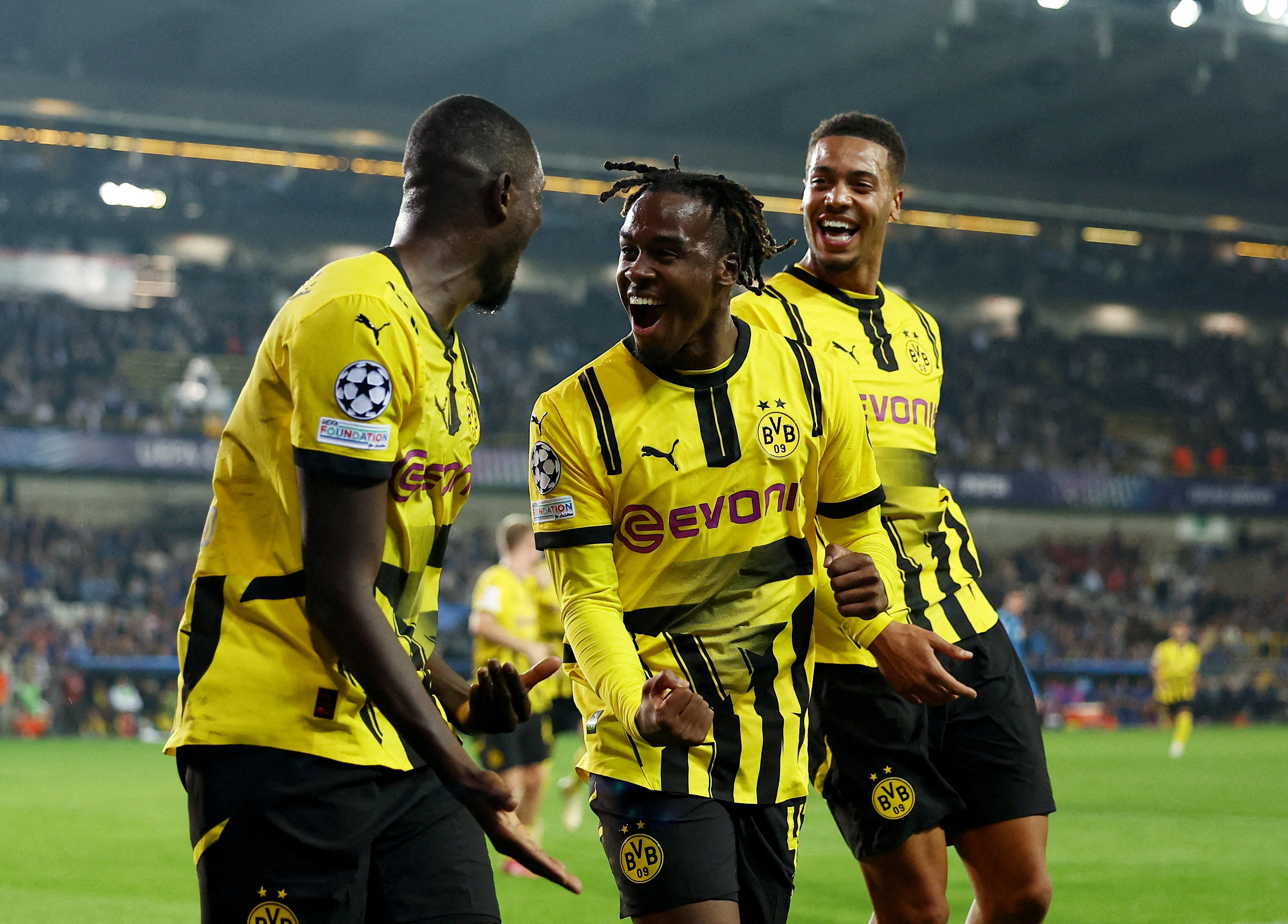 Soccer Football - Champions League - Club Brugge v Borussia Dortmund - Jan Breydel Stadium, Bruges, Belgium - September 18, 2024 Borussia Dortmund's Serhou Guirassy celebrates scoring their third goal with Jamie Bynoe-Gittens and Felix Nmecha REUTERS/Yves Herman     TPX IMAGES OF THE DAY