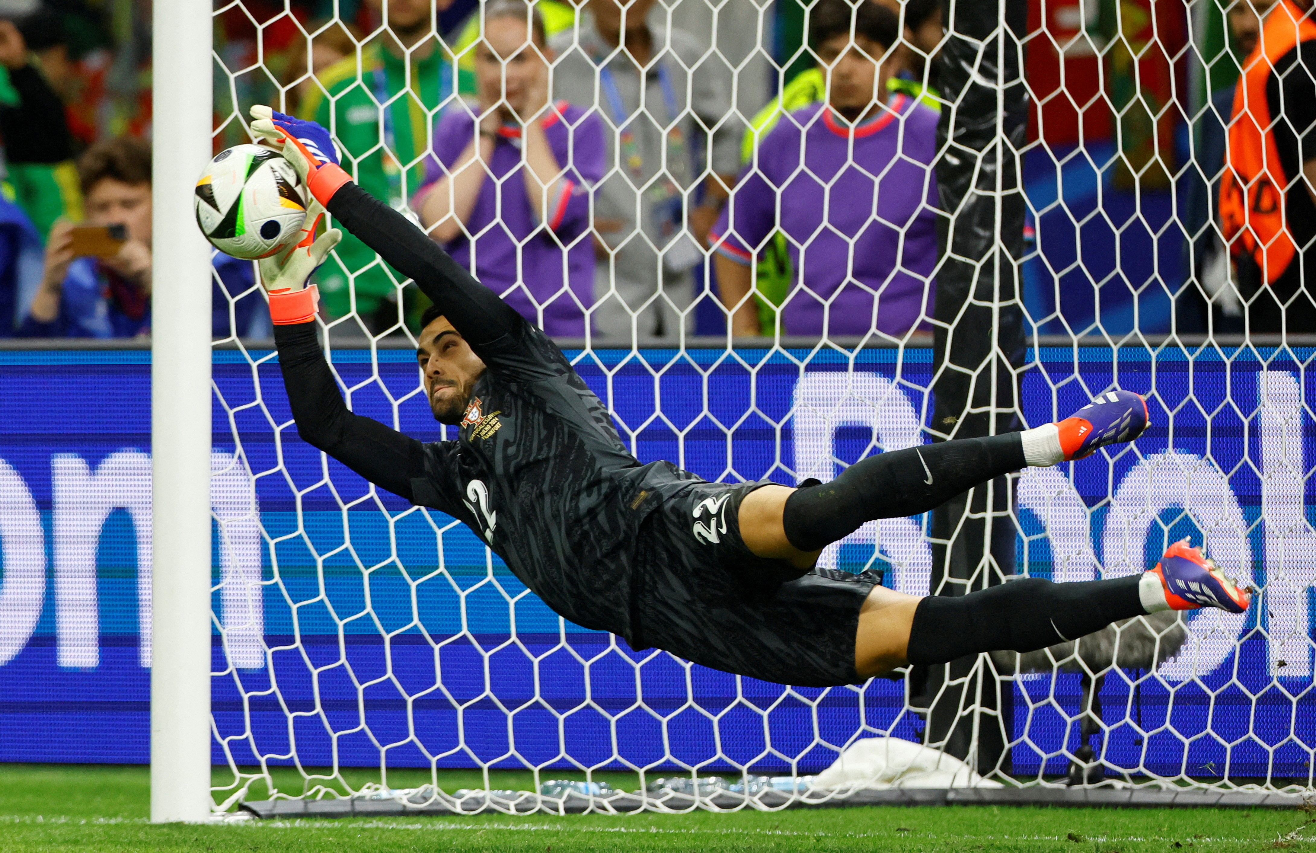 FILE PHOTO: Soccer Football - Euro 2024 - Round of 16 - Portugal v Slovenia - Frankfurt Arena, Frankfurt, Germany - July 1, 2024  Portugal's Diogo Costa saves a penalty during the shootout missed by Slovenia's Jure Balkovec REUTERS/Wolfgang Rattay/File Photo