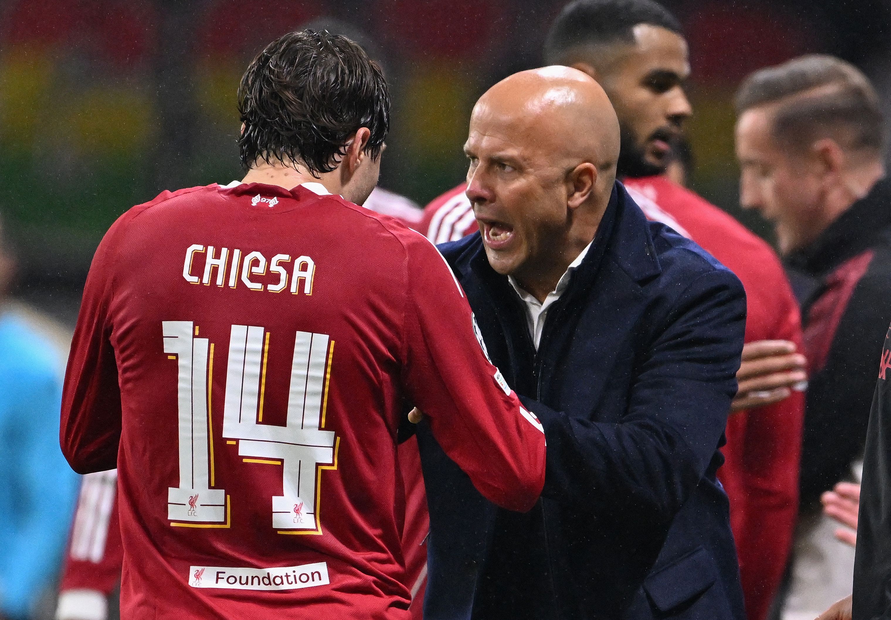 Liverpool's Dutch manager Arne Slot speaks with Liverpool's Italian striker #14 Federico Chiesa from the sidelines during the UEFA Champions League football match between Eintracht Frankfurt and Liverpool FC in Frankfurt, western Germany on October 22, 2025. (Photo by Kirill KUDRYAVTSEV / AFP)