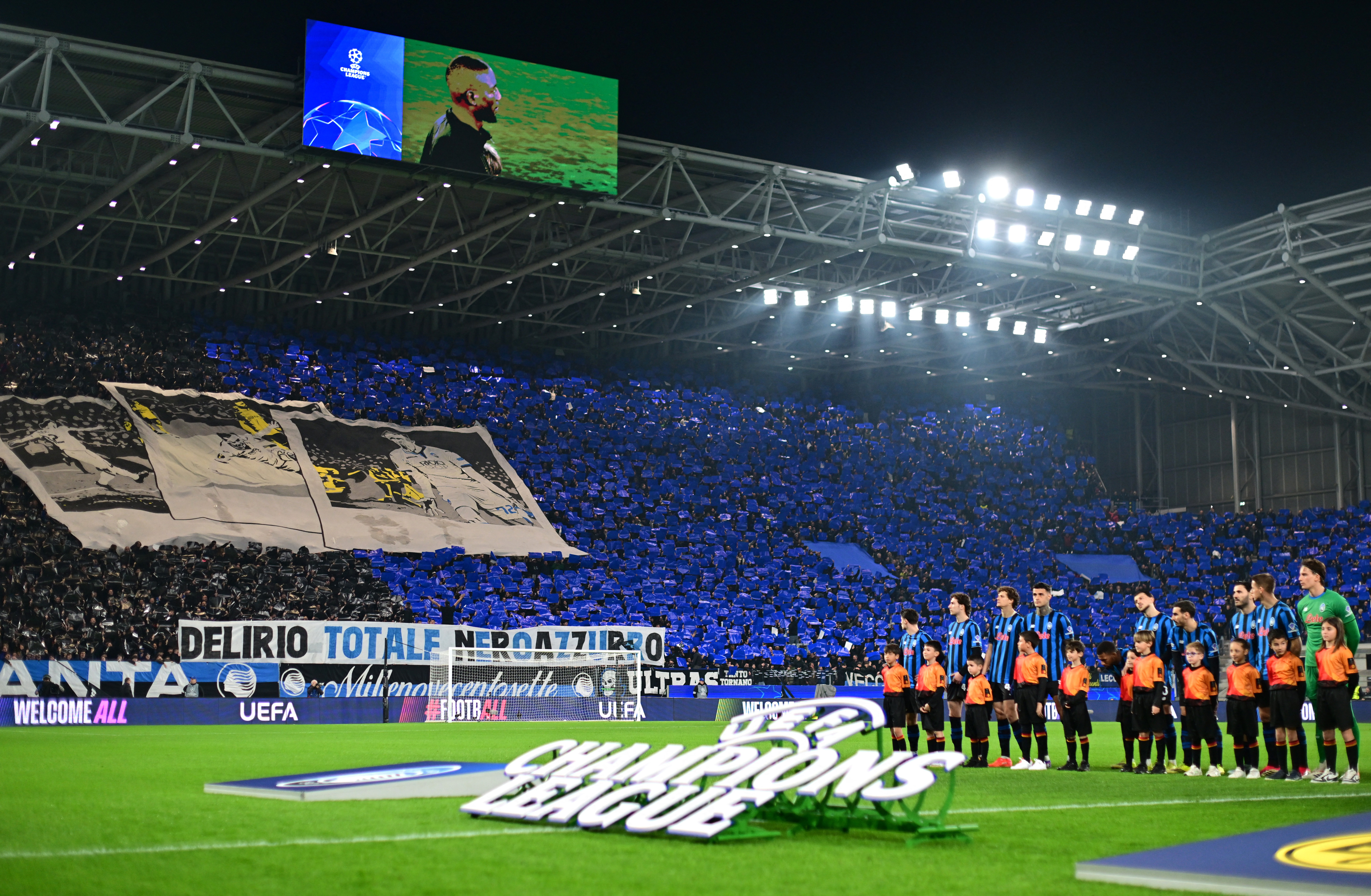 Soccer Football - UEFA Champions League - Play Off - Second Leg - Atalanta v Borussia Dortmund - New Balance Arena, Bergamo, Italy - February 25, 2026 Atalanta fans display banners as the players line up before the match REUTERS/Daniele Mascolo