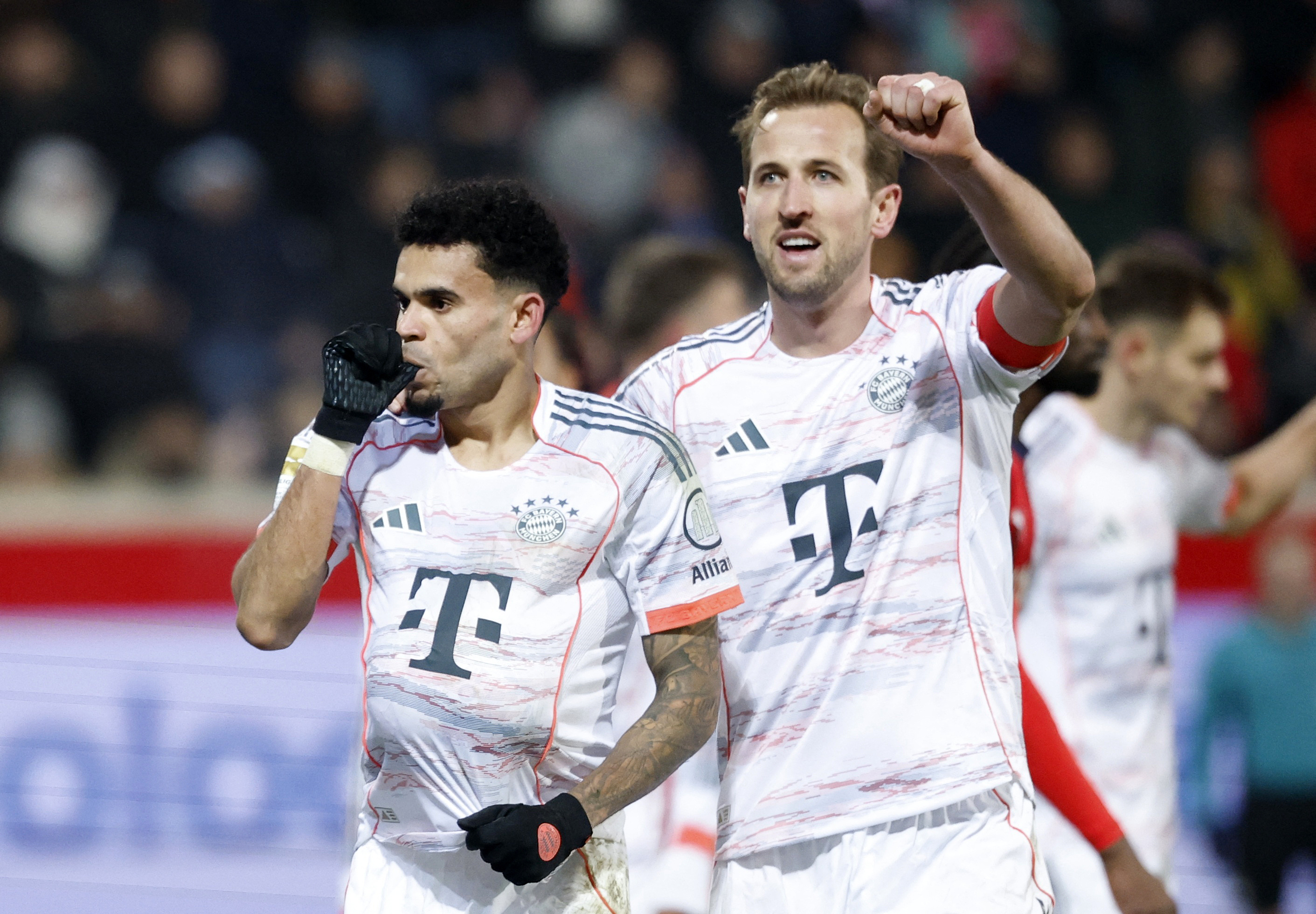 Soccer Football - Bundesliga - 1. FC Heidenheim v Bayern Munich - Voith-Arena, Heidenheim, Germany - December 21, 2025 Bayern Munich's Luis Diaz celebrates scoring their third goal with Harry Kane REUTERS/Heiko Becker DFL REGULATIONS PROHIBIT ANY USE OF PHOTOGRAPHS AS IMAGE SEQUENCES AND/OR QUASI-VIDEO.
