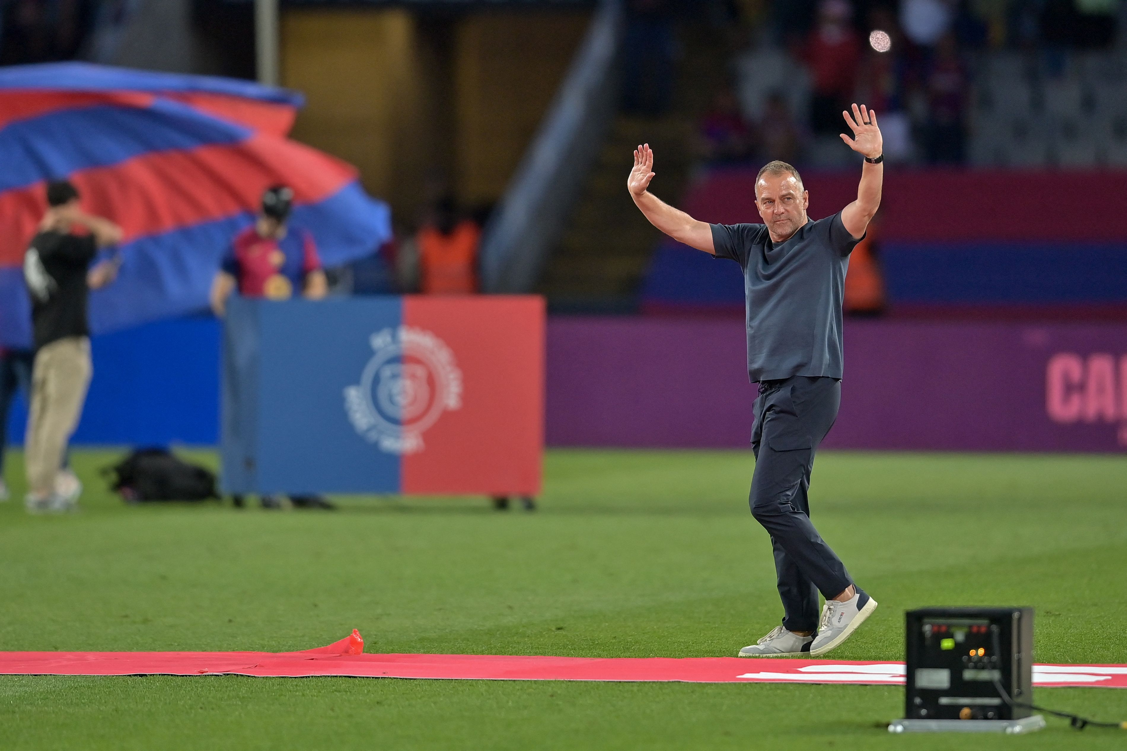 Barcelona's German coach Hans-Dieter Flick waves as he celebrates their 28th Liga title after the Spanish league football match between FC Barcelona and Villarreal CF at Estadi Olimpic Lluis Companys in Barcelona on May 18, 2025. (Photo by MANAURE QUINTERO / AFP)