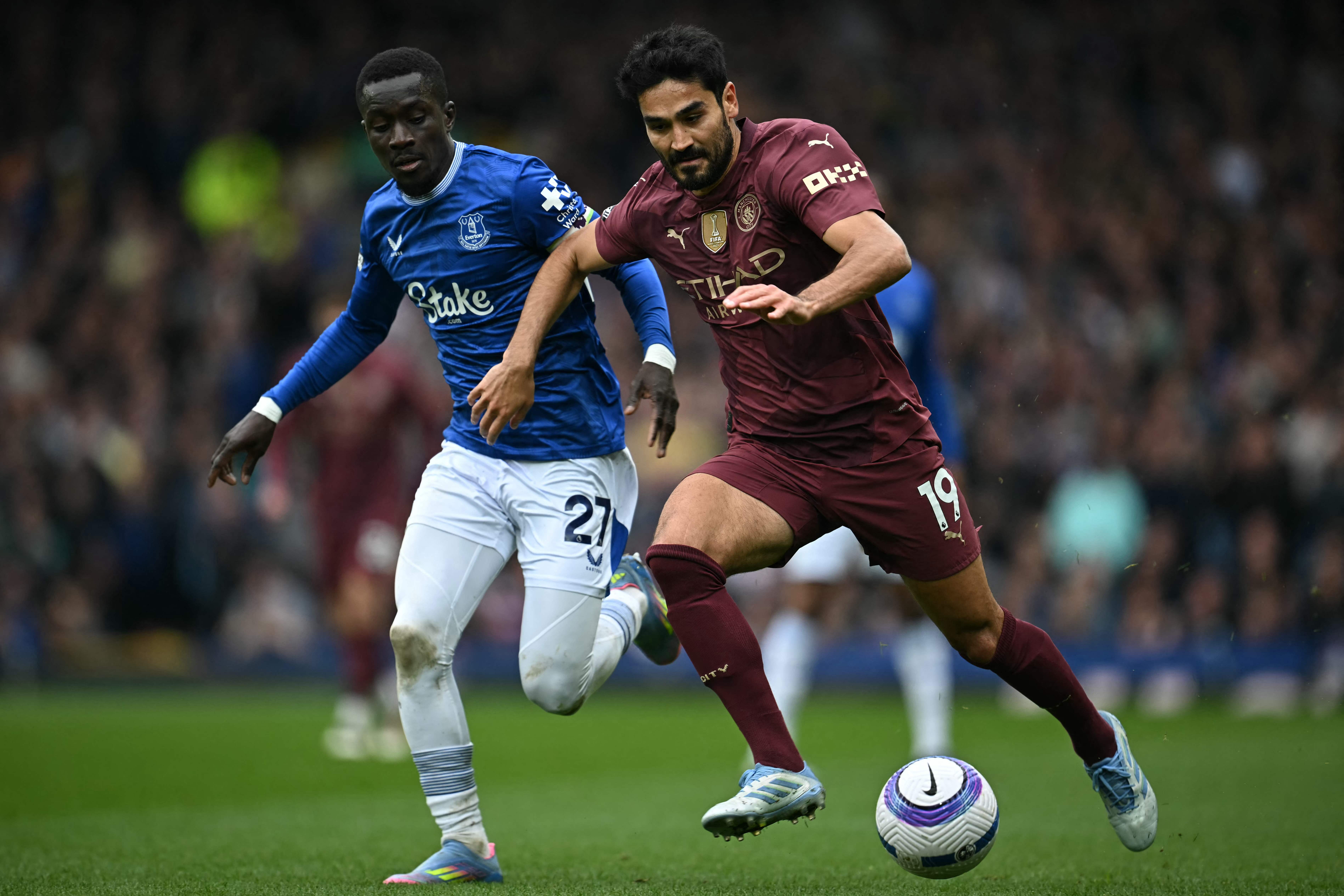 Everton's Senegalese midfielder #27 Idrissa Gueye (L) vies with Manchester City's German midfielder #19 Ilkay Gundogan (R) during the English Premier League football match between Everton and Manchester City at Goodison Park in Liverpool, north west England on April 19, 2025. (Photo by Paul ELLIS / AFP) / RESTRICTED TO EDITORIAL USE. No use with unauthorized audio, video, data, fixture lists, club/league logos or 'live' services. Online in-match use limited to 120 images. An additional 40 images may be used in extra time. No video emulation. Social media in-match use limited to 120 images. An additional 40 images may be used in extra time. No use in betting publications, games or single club/league/player publications. /