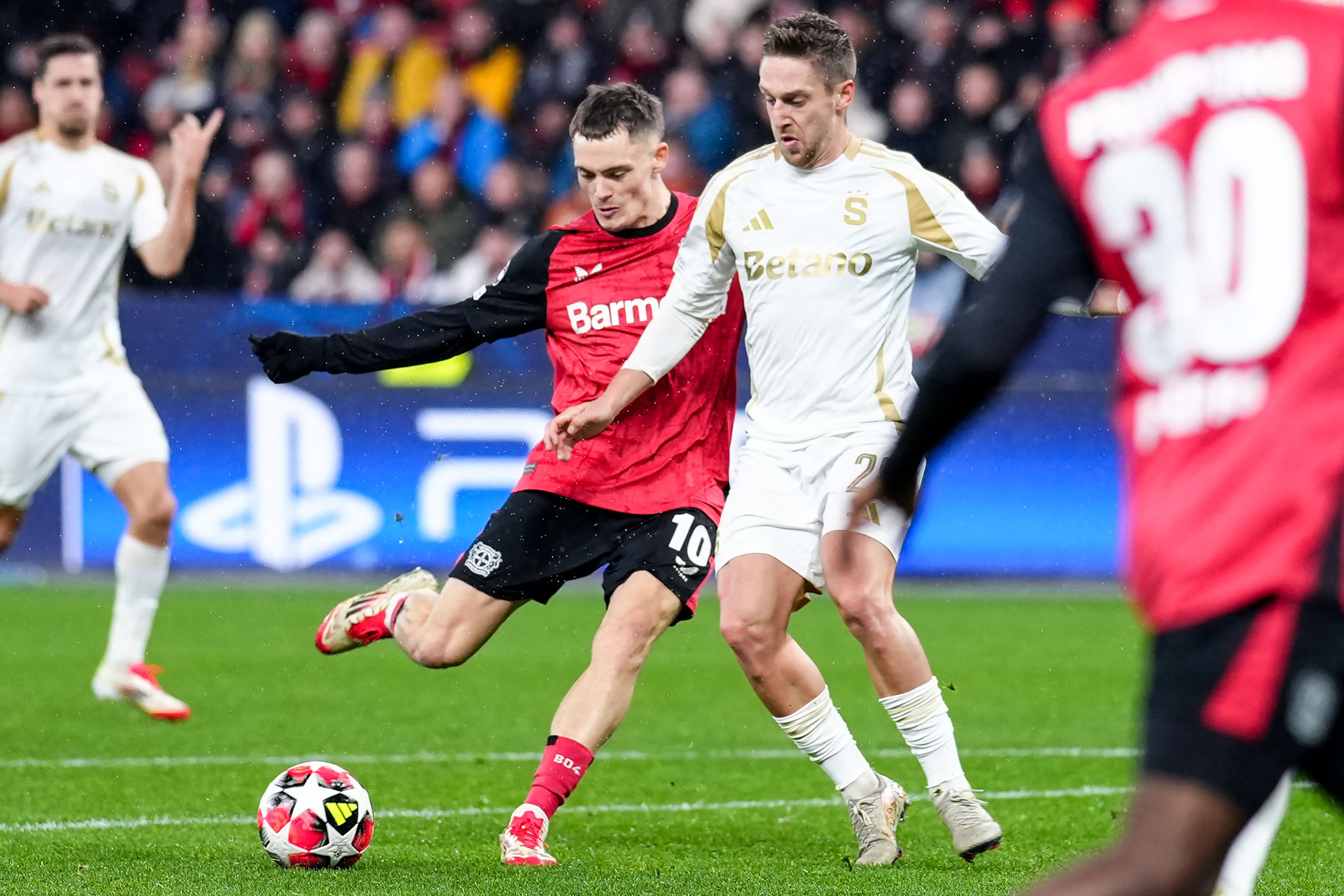 Bayer Leverkusen's German midfielder #10 Florian Wirtz (L) scores the 1-0 goal during the UEFA Champions League football match between Bayer 04 Leverkusen and Sparta Prague in Leverkusen, western Germany on January 29, 2025. (Photo by Pau BARRENA / AFP)