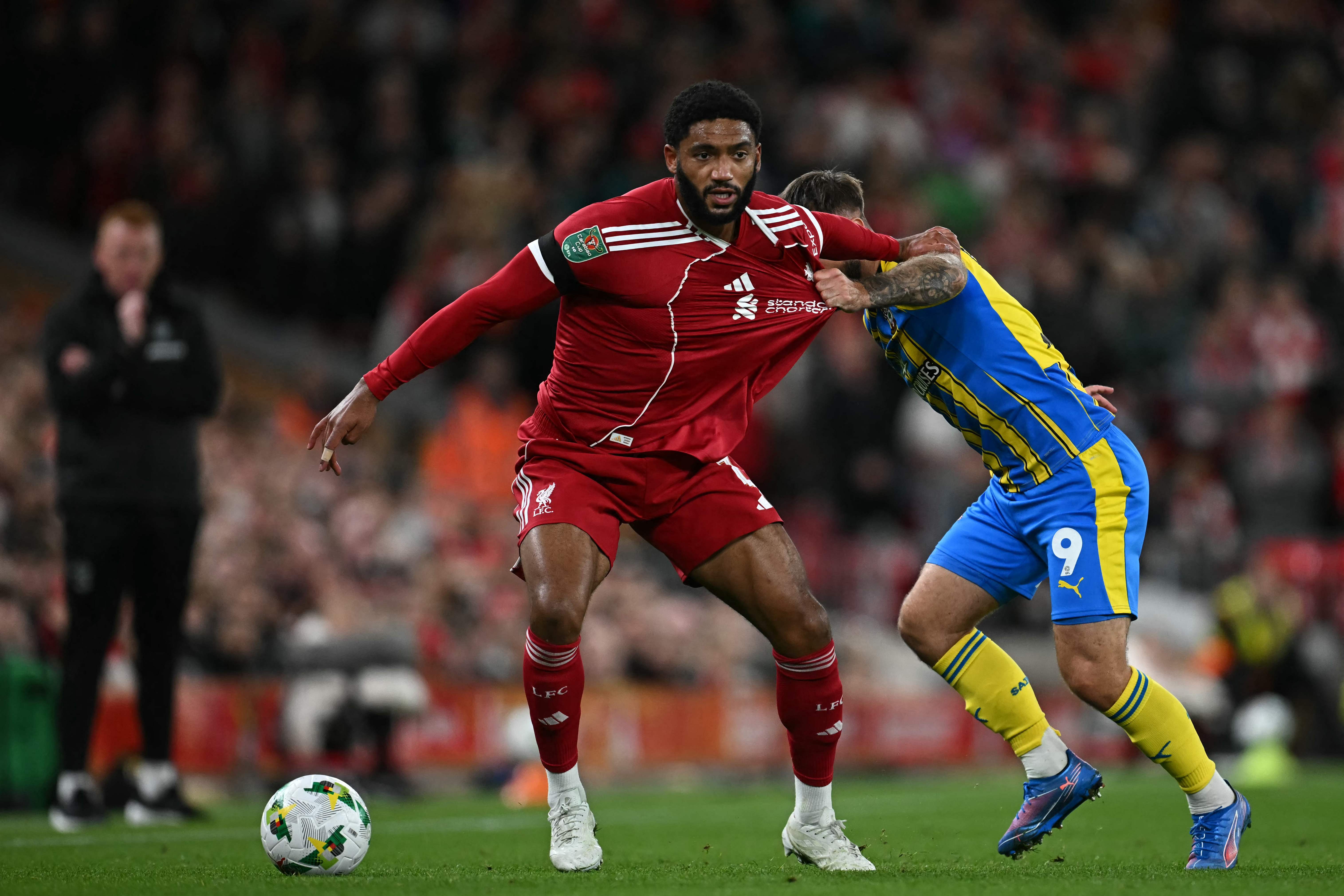 Liverpool's English defender #02 Joe Gomez (C) vies with Southampton's English striker #09 Adam Armstrong (R) during the English League Cup third round football match between Liverpool and Southampton at Anfield in Liverpool, north west England on September 23, 2025. (Photo by Paul ELLIS / AFP) / RESTRICTED TO EDITORIAL USE. No use with unauthorized audio, video, data, fixture lists, club/league logos or 'live' services. Online in-match use limited to 120 images. An additional 40 images may be used in extra time. No video emulation. Social media in-match use limited to 120 images. An additional 40 images may be used in extra time. No use in betting publications, games or single club/league/player publications. /