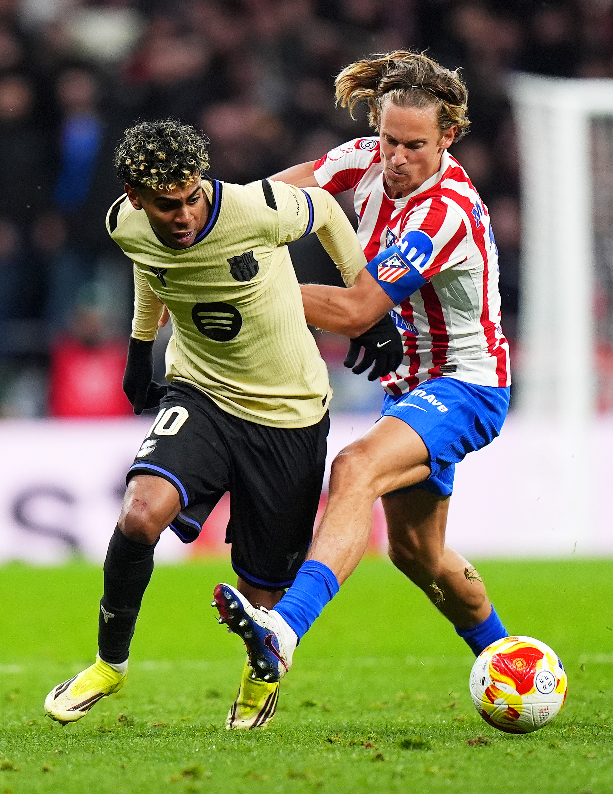 MADRID, SPAIN - FEBRUARY 12: Lamine Yamal of FC Barcelona is challenged by Marcos Llorente of Atletico de Madrid during the Copa Del Rey Semi-Final First Leg match between Atletico de Madrid and FC Barcelona at Riyadh Air Metropolitano on February 12, 2026 in Madrid, Spain.  (Photo by Angel Martinez/Getty Images)