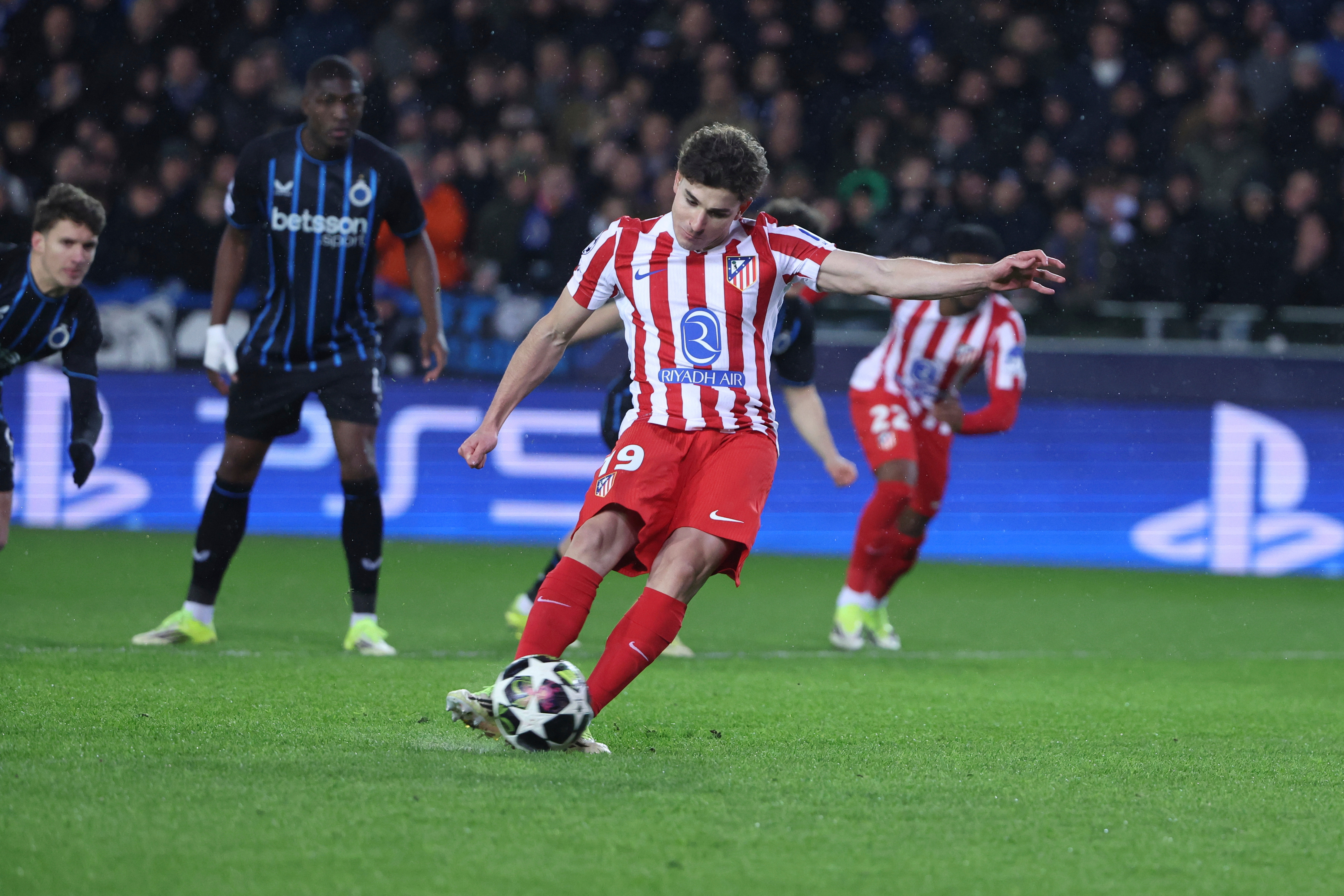 Atletico Madrid's Julian Alvarez scores the opening goal by a penalty during the Champions League play-off first leg soccer match between Club Brugge and Atletico Madrid, in Bruges, Belgium, Wednesday, Feb. 18, 2026. (AP Photo/Omar Havana)