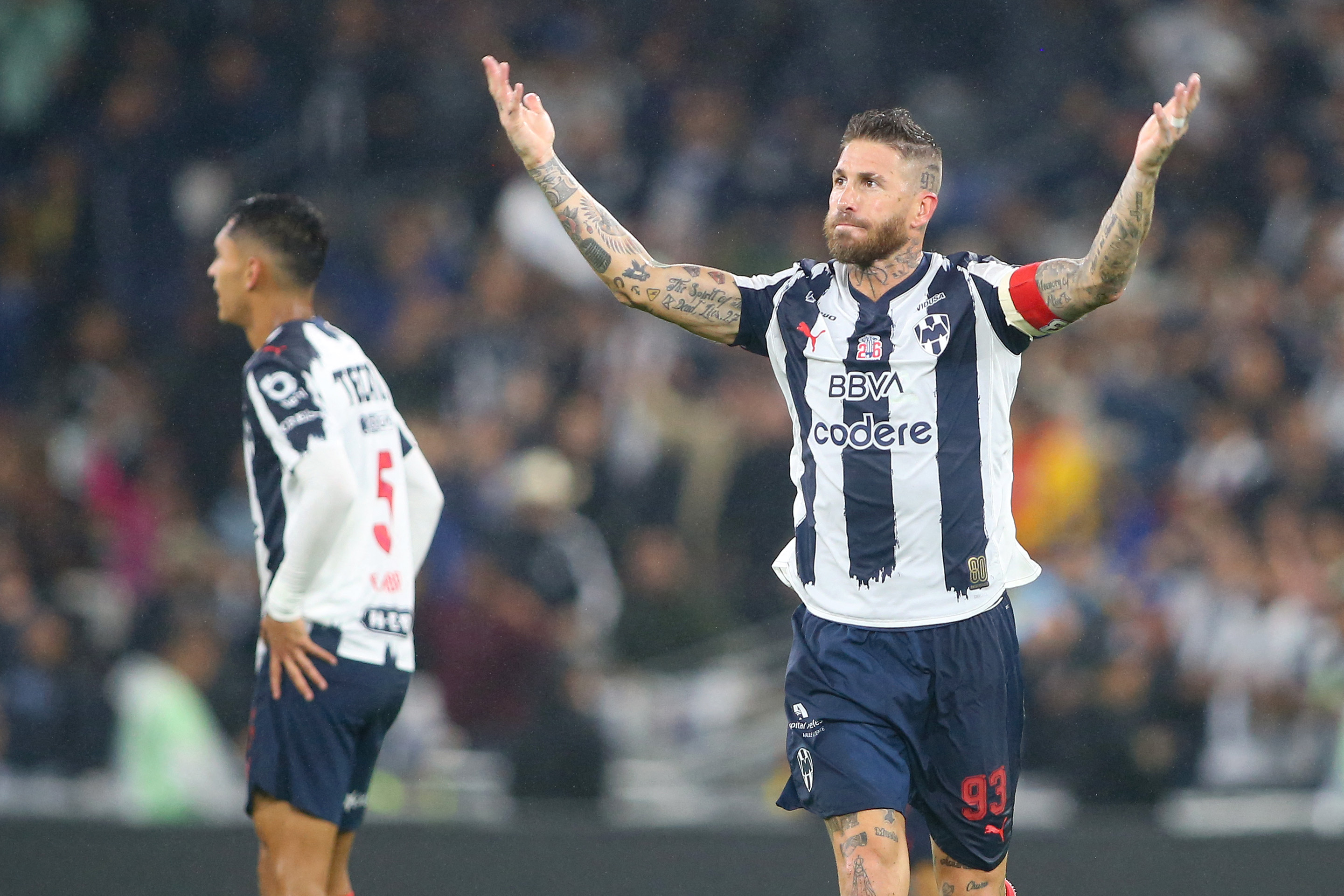 Monterrey's Spanish defender #93 Sergio Ramos (R) celebrates after his team's second goal during the Liga MX Apertura quarter-final first leg football match between Monterrey and America at the BBVA Stadium in Monterrey, Nuevo Leon state, Mexico, on November 26, 2025. (Photo by Julio Cesar AGUILAR / AFP)