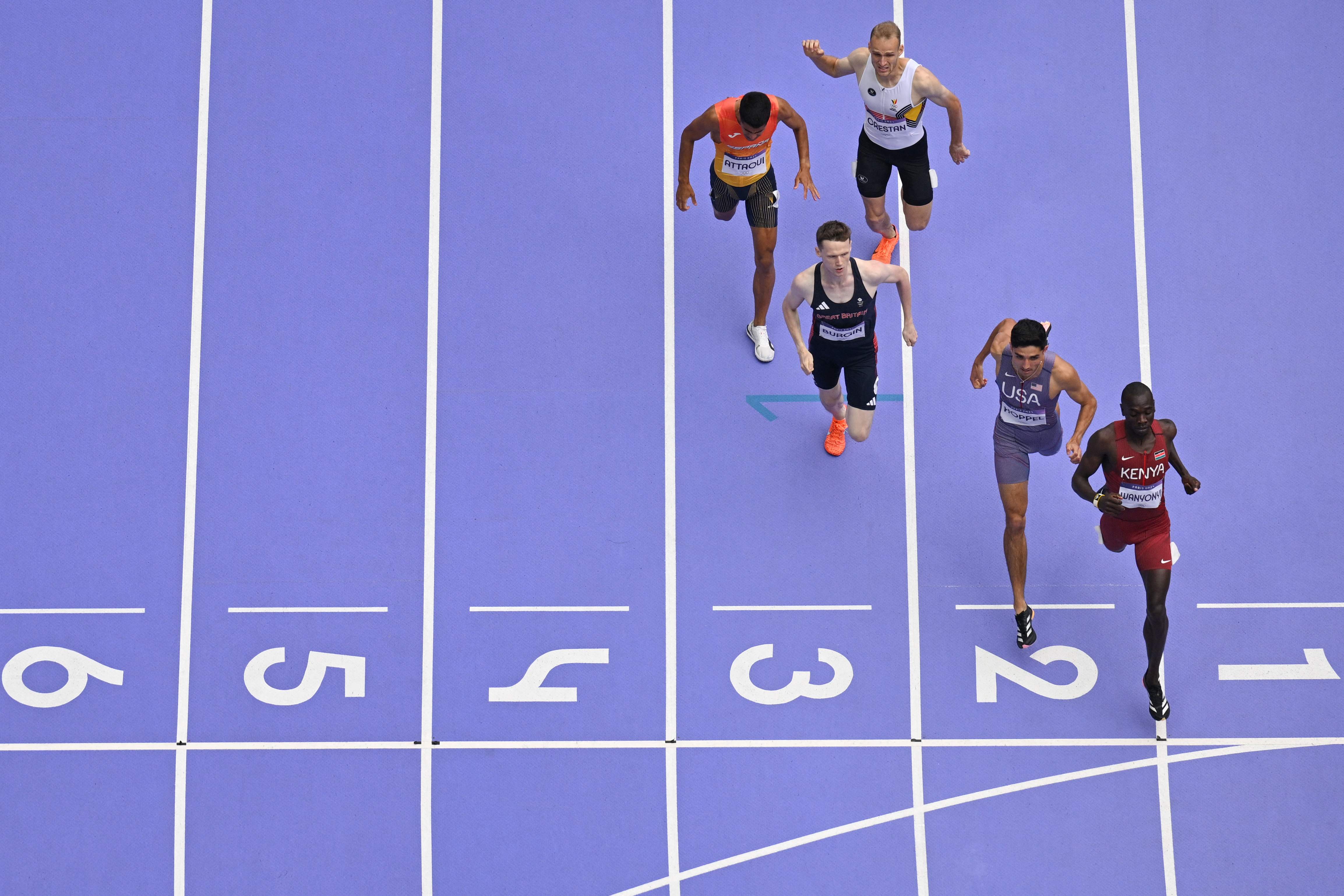 Kenya's Emmanuel Wanyonyi crosses the finish line ahead of Britain's Max Burgin, US' Bryce Hoppel and Spain's Mohamed Attaoui in the men's 800m semi-final of the athletics event at the Paris 2024 Olympic Games at Stade de France in Saint-Denis, north of Paris, on August 9, 2024. (Photo by Jewel SAMAD / AFP)