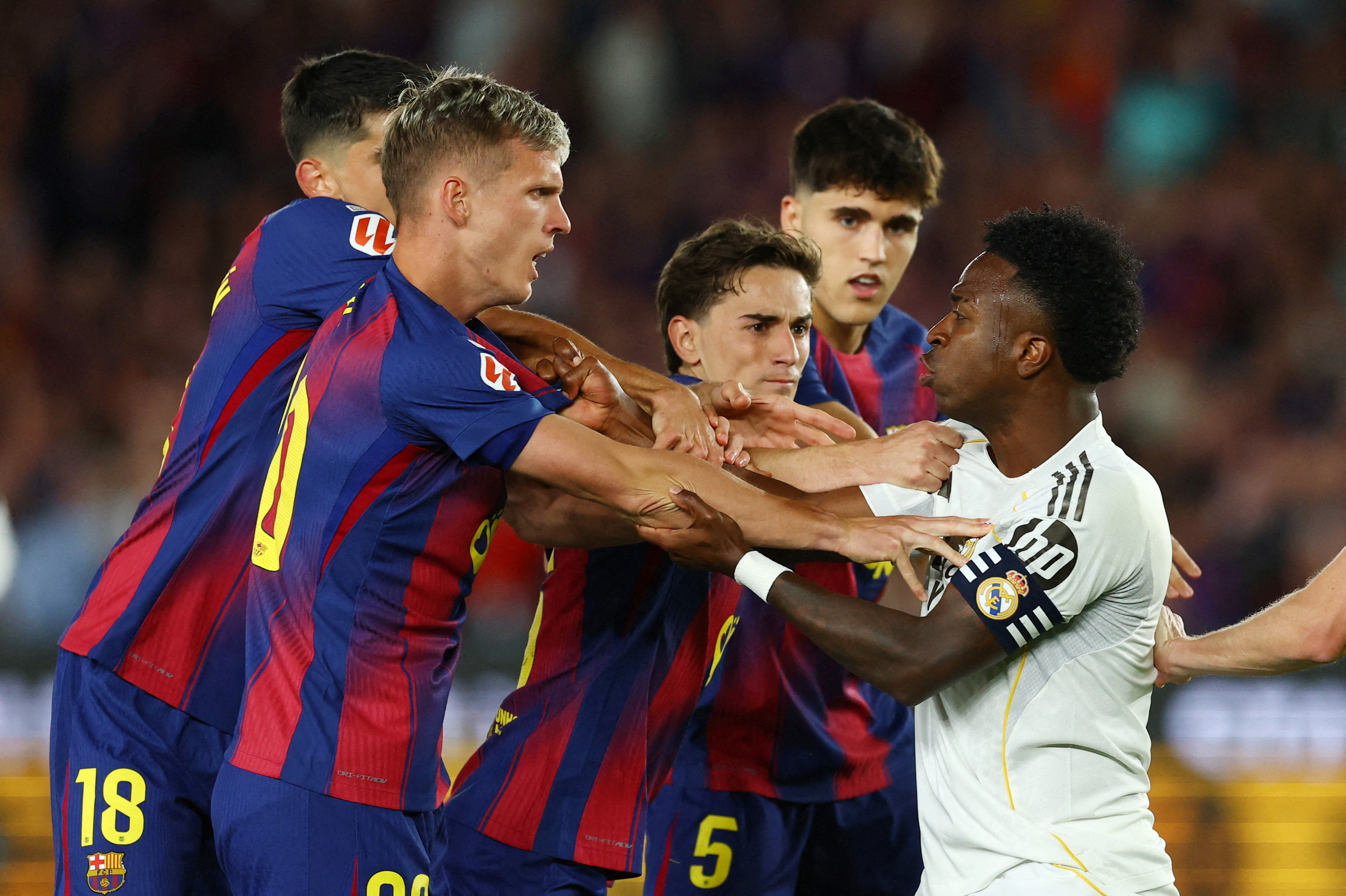 Soccer Football - LaLiga - FC Barcelona v Real Madrid - Spotify Camp Nou, Barcelona, Spain - May 10, 2026 Real Madrid's Vinicius Junior clashes with FC Barcelona's Dani Olmo, Gavi and Gerard Martin REUTERS/Albert Gea TPX IMAGES OF THE DAY