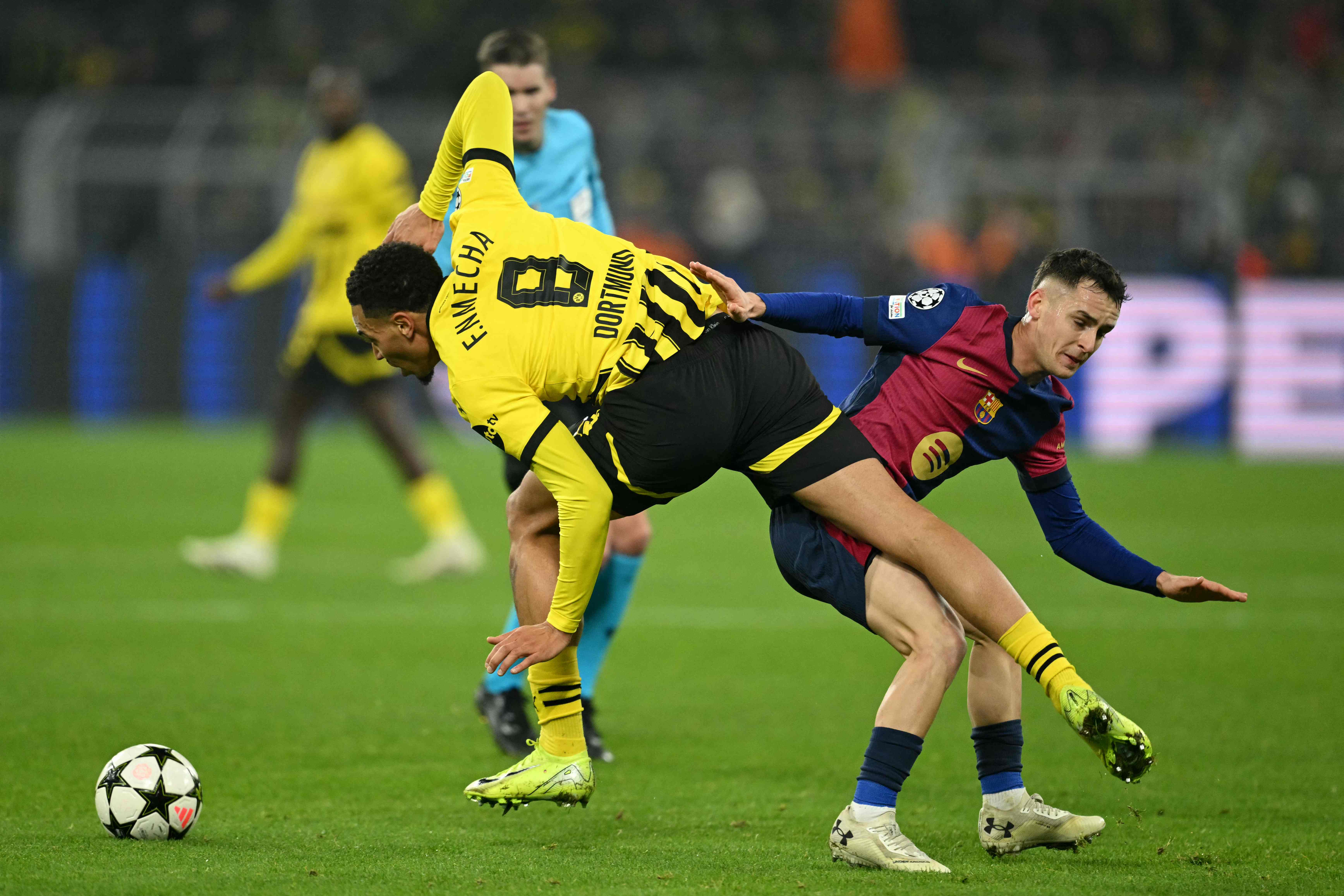 Barcelona's Spanish midfielder #17 Marc Casado (R) and Borussia Dortmund's German midfielder #08 Felix Nmecha vie for the ball during the UEFA Champions League football match between Borussia Dortmund and FC Barcelona in Dortmund, western Germany on December 11, 2024. (Photo by INA FASSBENDER / AFP)