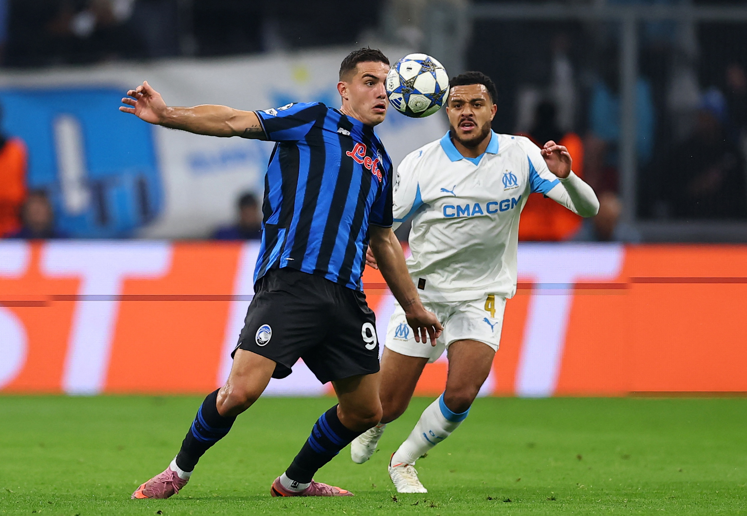 Soccer Football - UEFA Champions League - Olympique de Marseille v Atalanta - Orange Velodrome, Marseille, France - November 5, 2025 Atalanta's Nikola Krstovic in action with Olympique de Marseille's CJ Egan-Riley REUTERS/Manon Cruz