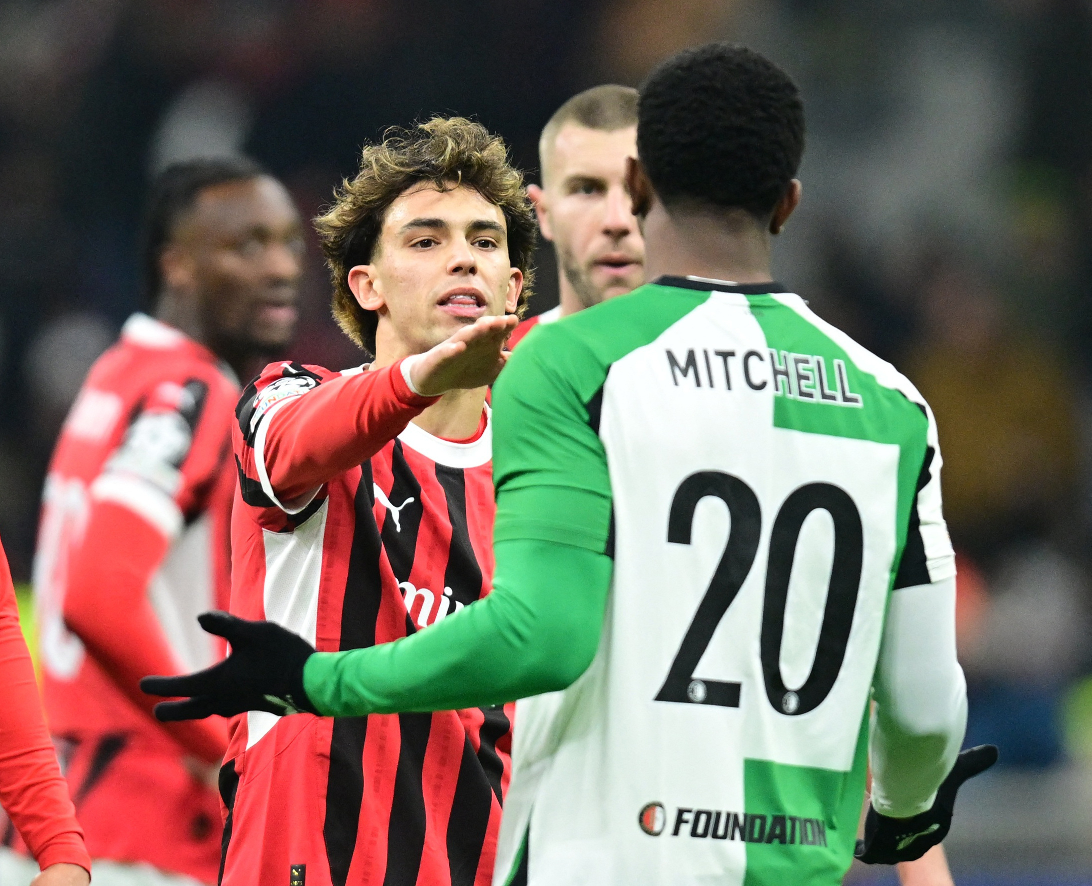 Soccer Football - Champions League - Knockout Phase Playoff - Second Leg - AC Milan v Feyenoord - San Siro, Milan, Italy - February 18, 2025 AC Milan's Joao Felix reacts with Feyenoord's Jeyland Mitchell REUTERS/Daniele Mascolo