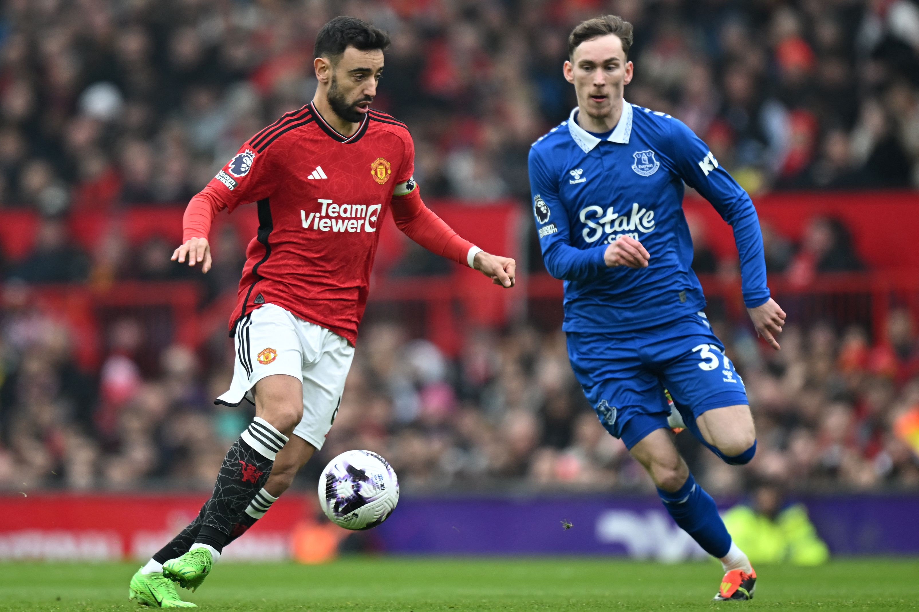 Manchester United's Portuguese midfielder #08 Bruno Fernandes (L) vies with Everton's English midfielder #37 James Garner (R) during the English Premier League football match between Manchester United and Everton at Old Trafford in Manchester, north west England, on March 9, 2024. (Photo by Paul ELLIS / AFP) / RESTRICTED TO EDITORIAL USE. No use with unauthorized audio, video, data, fixture lists, club/league logos or 'live' services. Online in-match use limited to 120 images. An additional 40 images may be used in extra time. No video emulation. Social media in-match use limited to 120 images. An additional 40 images may be used in extra time. No use in betting publications, games or single club/league/player publications. / 