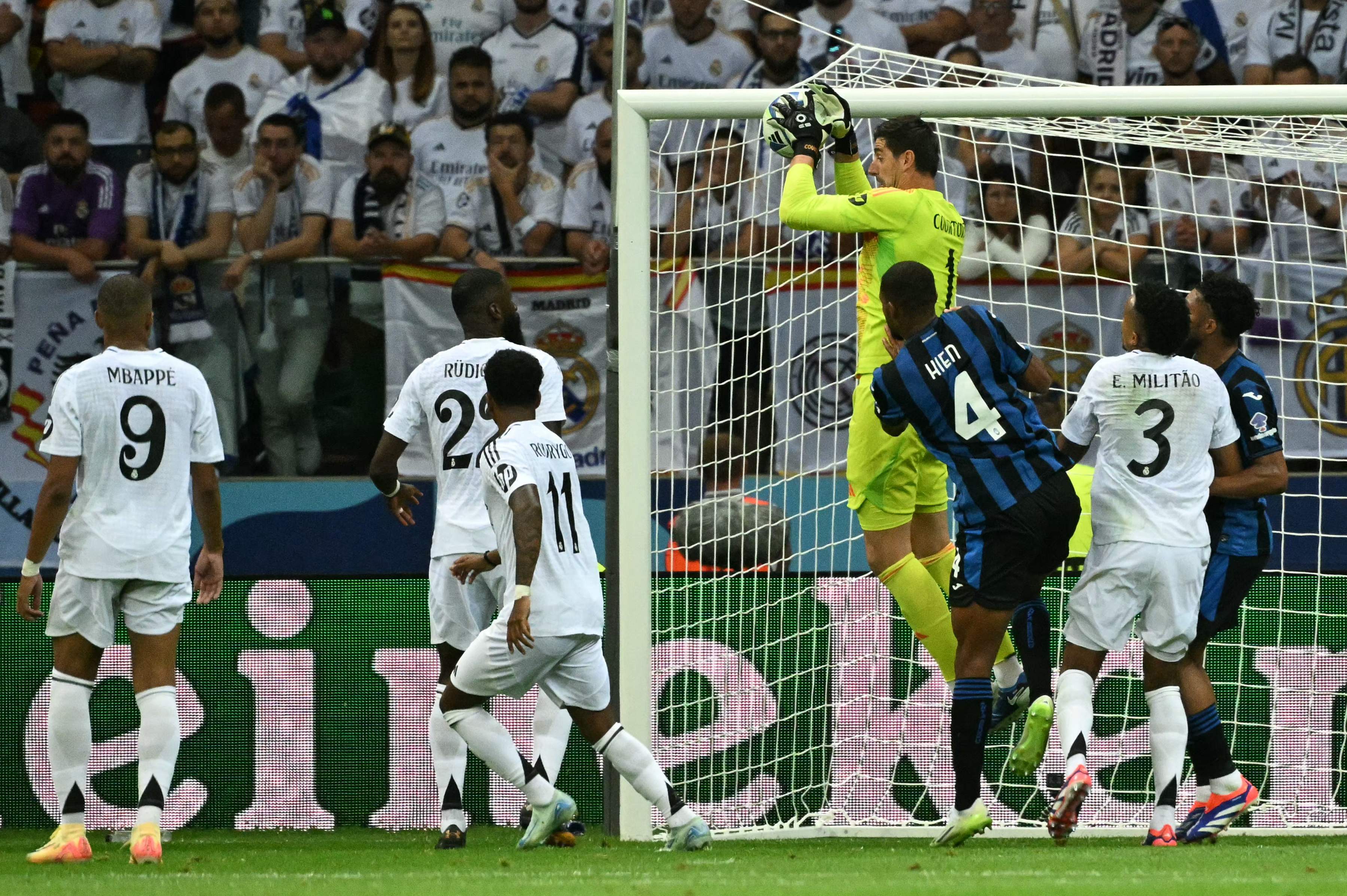 Real Madrid's Belgian goalkeeper Thibaut Courtois makes a save during the UEFA Super Cup football match between Real Madrid and Atalanta BC in Warsaw, on August 14, 2024. (Photo by Sergei GAPON / AFP)