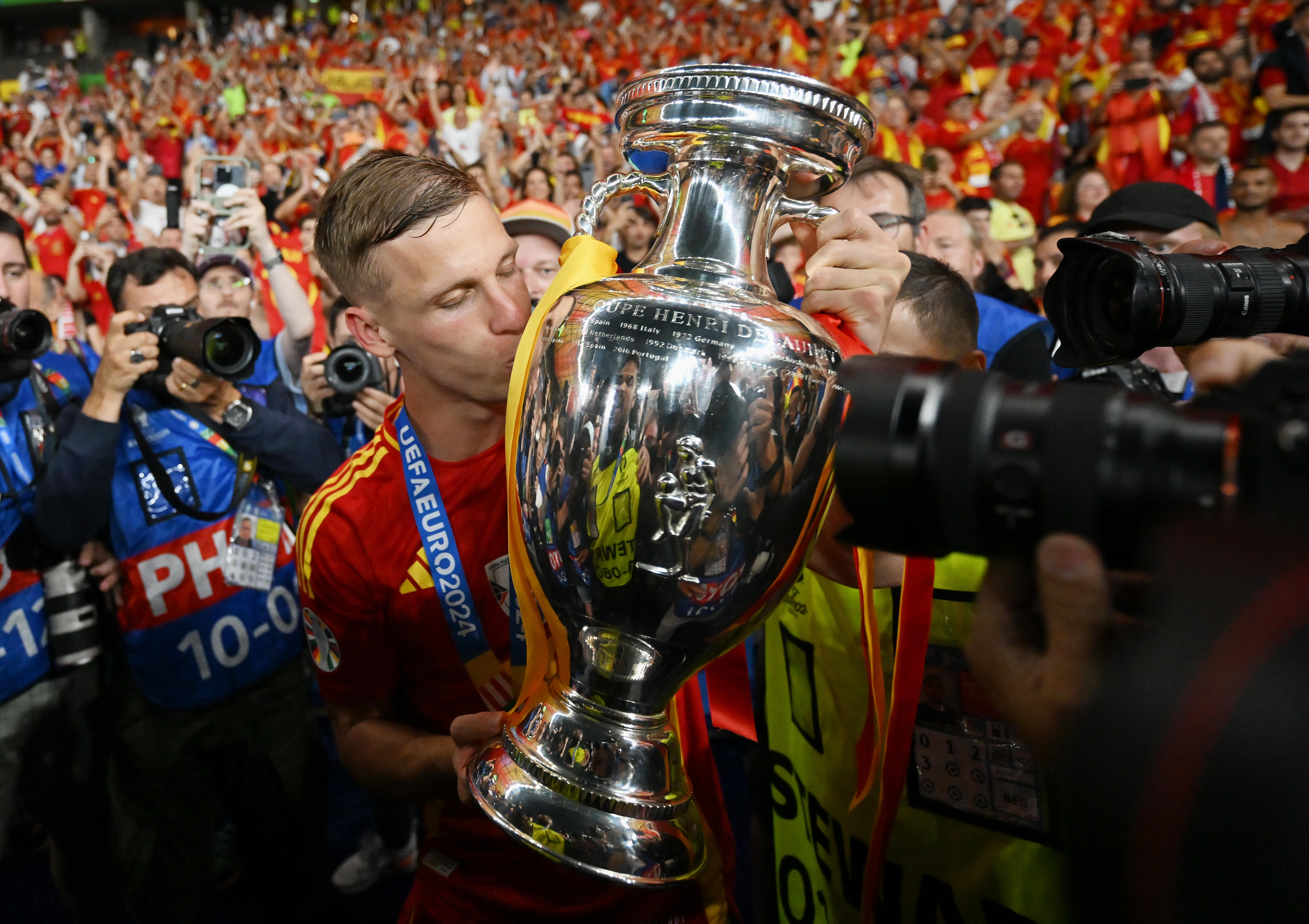 BERLIN, GERMANY - JULY 14: Dani Olmo of Spain kisses the UEFA Euro 2024 Henri Delaunay Trophy after his team's victory in the UEFA EURO 2024 final match between Spain and England at Olympiastadion on July 14, 2024 in Berlin, Germany. (Photo by Dan Mullan/Getty Images)