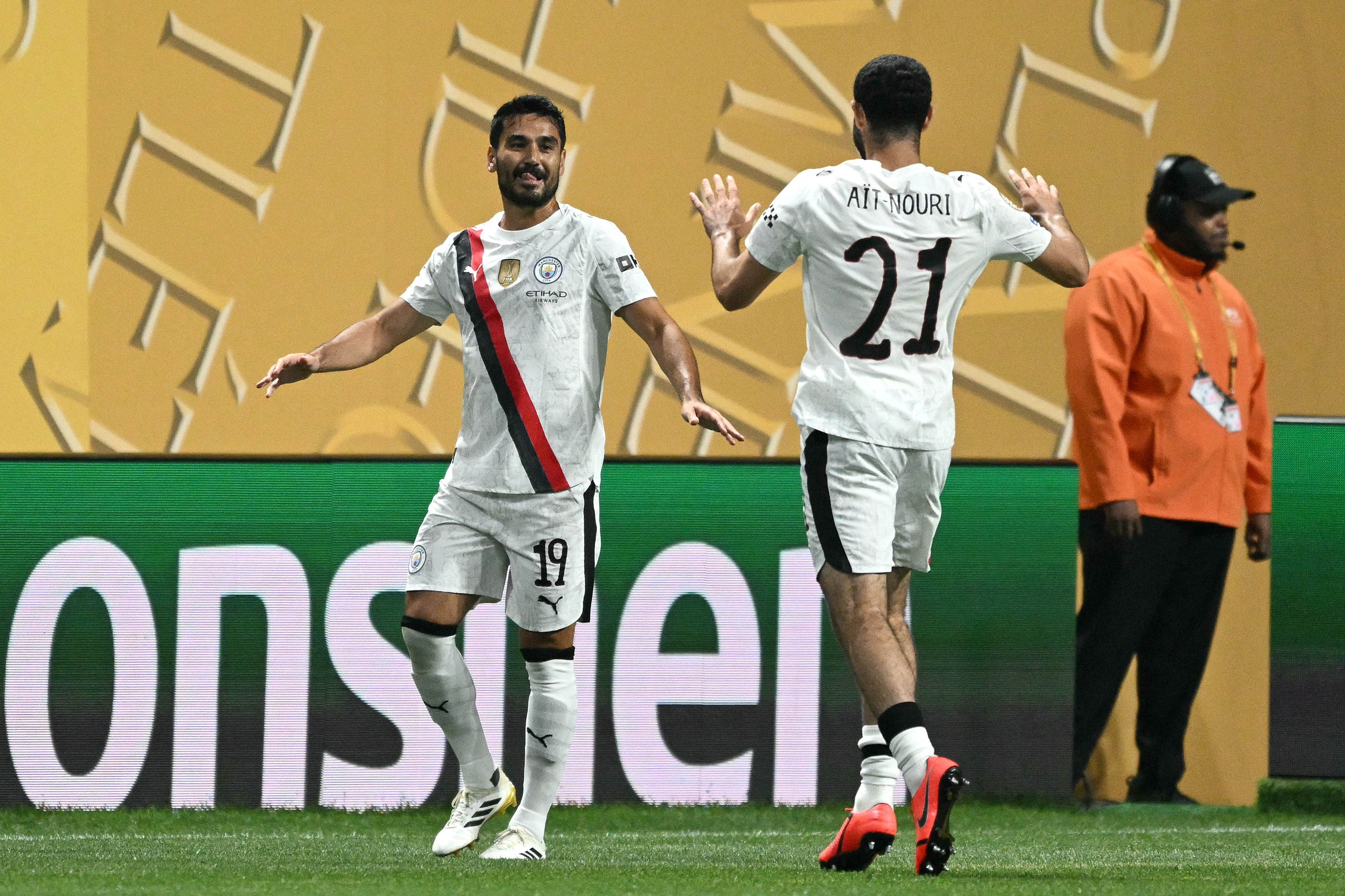 Manchester City's German midfielder #19 Ilkay Gundogan (L) celebrates with teammate Algerian defender #21 Rayan Ait-Nouri after scoring his team's first goal during the FIFA Club World Cup 2025 Group G football match between England's Manchester City and UAE's Al Ain FC at the Mercedes-Benz stadium in Atlanta on June 22, 2025. (Photo by CHANDAN KHANNA / AFP)