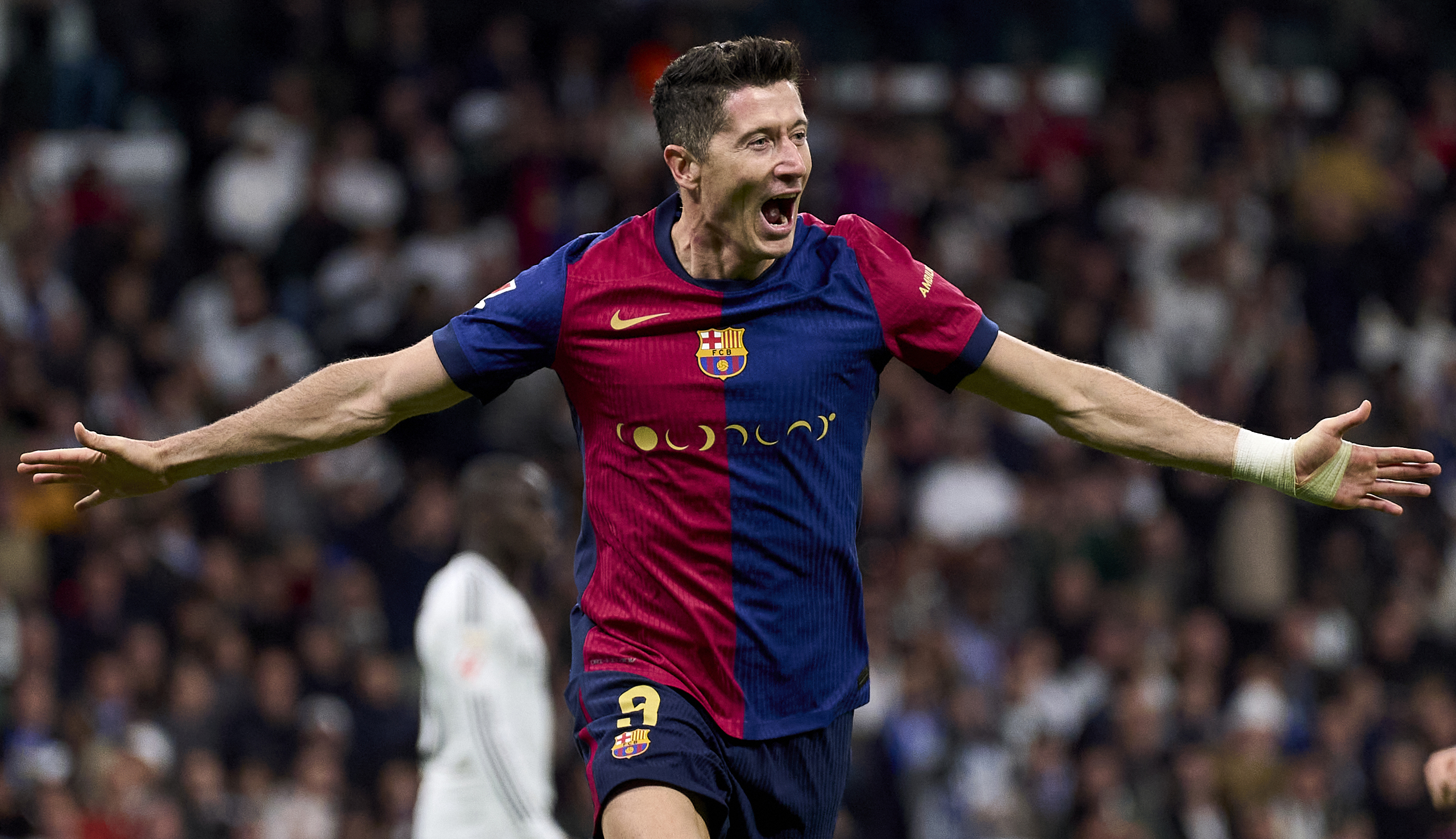 MADRID, SPAIN - OCTOBER 26: Robert Lewandowski of FC Barcelona celebrates his team second goal during the LaLiga match between Real Madrid CF and FC Barcelona at Estadio Santiago Bernabeu on October 26, 2024 in Madrid, Spain. (Photo by Diego Souto/Getty Images)