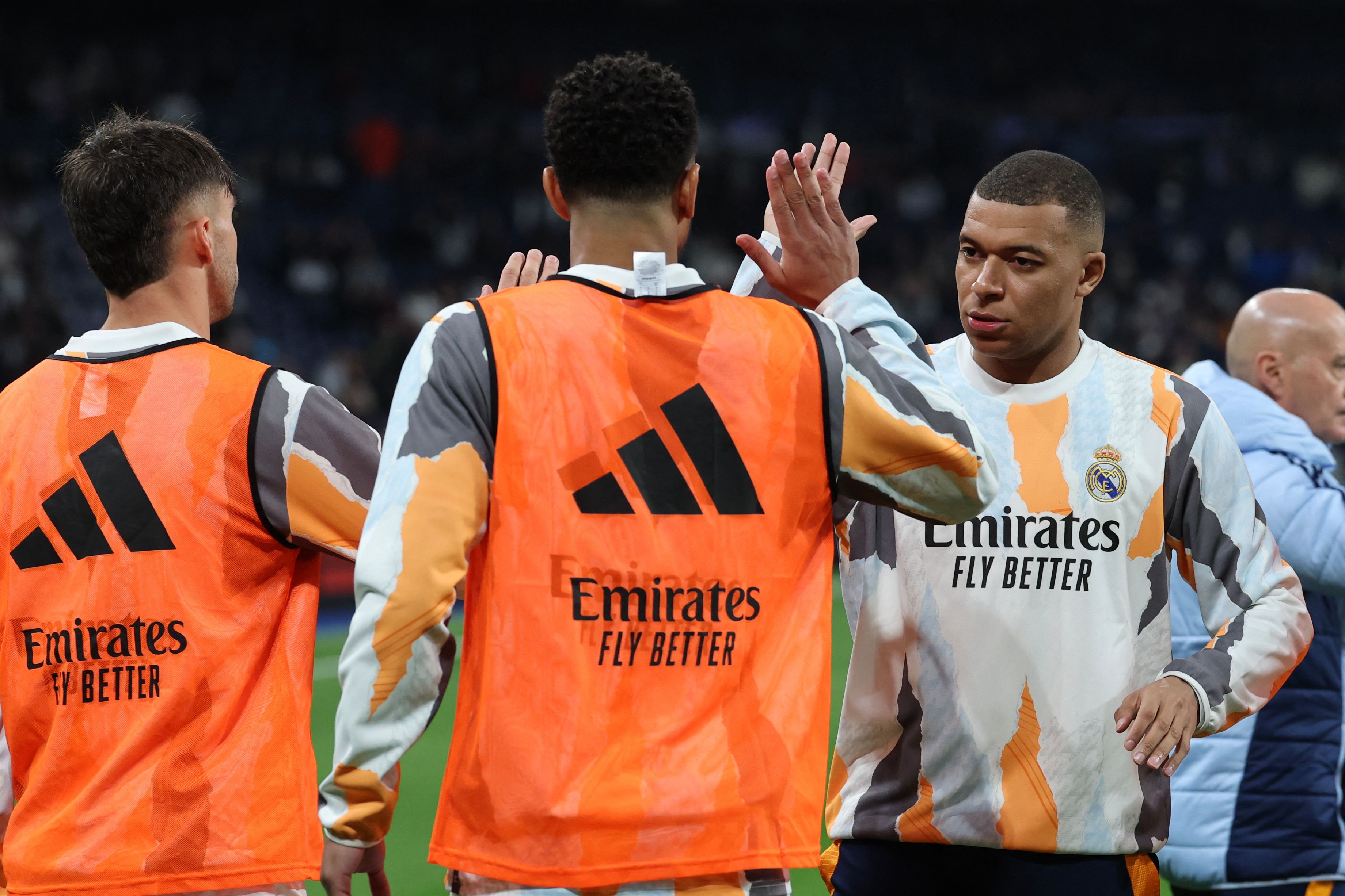 Real Madrid's French forward #09 Kylian Mbappe (R) and teammates warm up before the Spanish league football match between Real Madrid CF and Club Atletico de Madrid at Santiago Bernabeu Stadium in Madrid on February 8, 2025. (Photo by Thomas COEX / AFP)