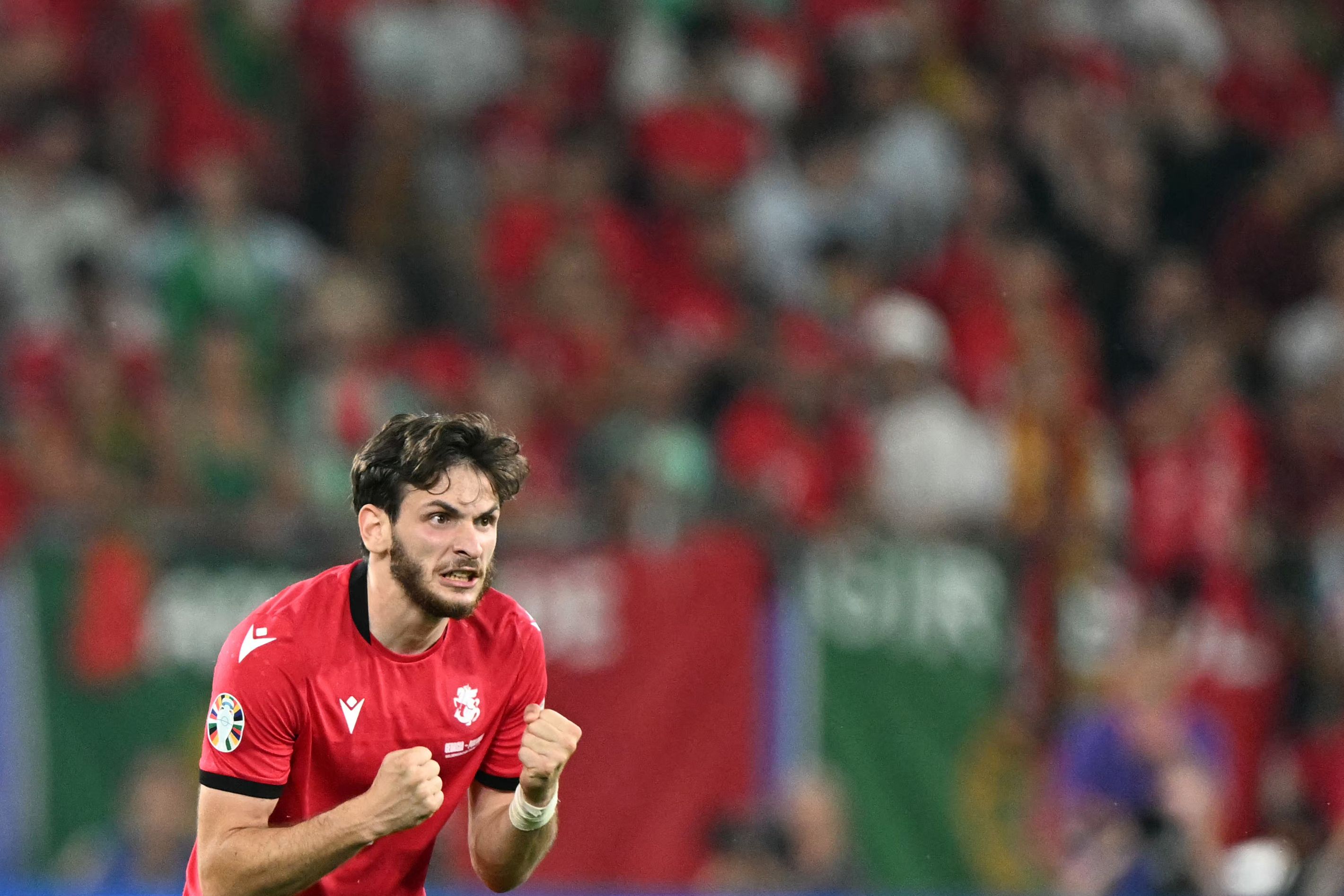 Georgia's forward #07 Khvicha Kvaratskhelia celebrates his team's second goal during the UEFA Euro 2024 Group F football match between Georgia and Portugal at the Arena AufSchalke in Gelsenkirchen on June 26, 2024. (Photo by PATRICIA DE MELO MOREIRA / AFP)