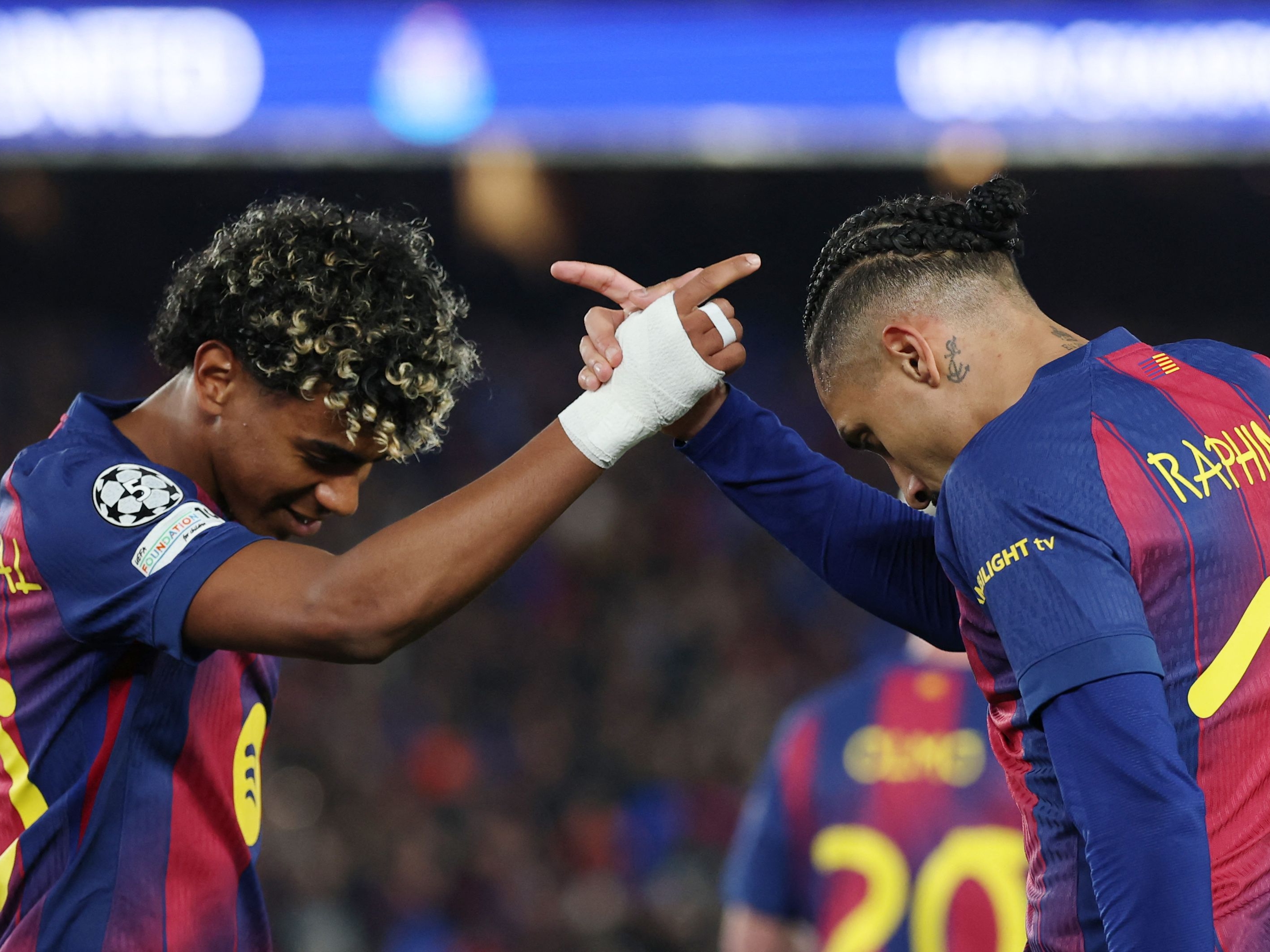 Barcelona's Brazilian forward #11 Raphinha celebrates scoring his team's seventh goal with Barcelona's Spanish forward #10 Lamine Yamal (L) during the UEFA Champions League last 16 second leg football match between FC Barcelona and Newcastle United at the Camp Nou stadium in Barcelona, on March 18, 2026. (Photo by Lluis GENE / AFP)
